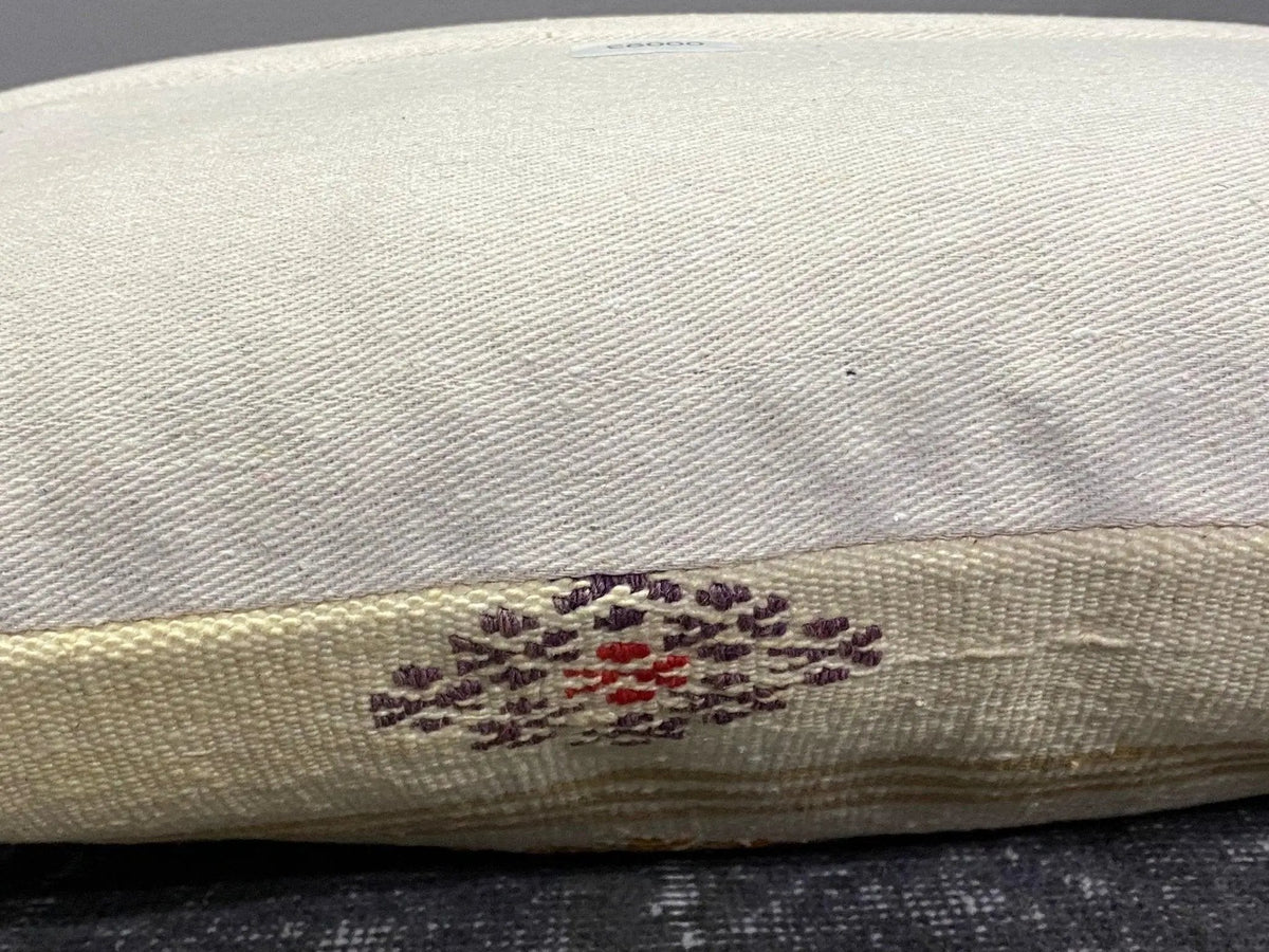 White Turkish throw pillow, shown on the floor.