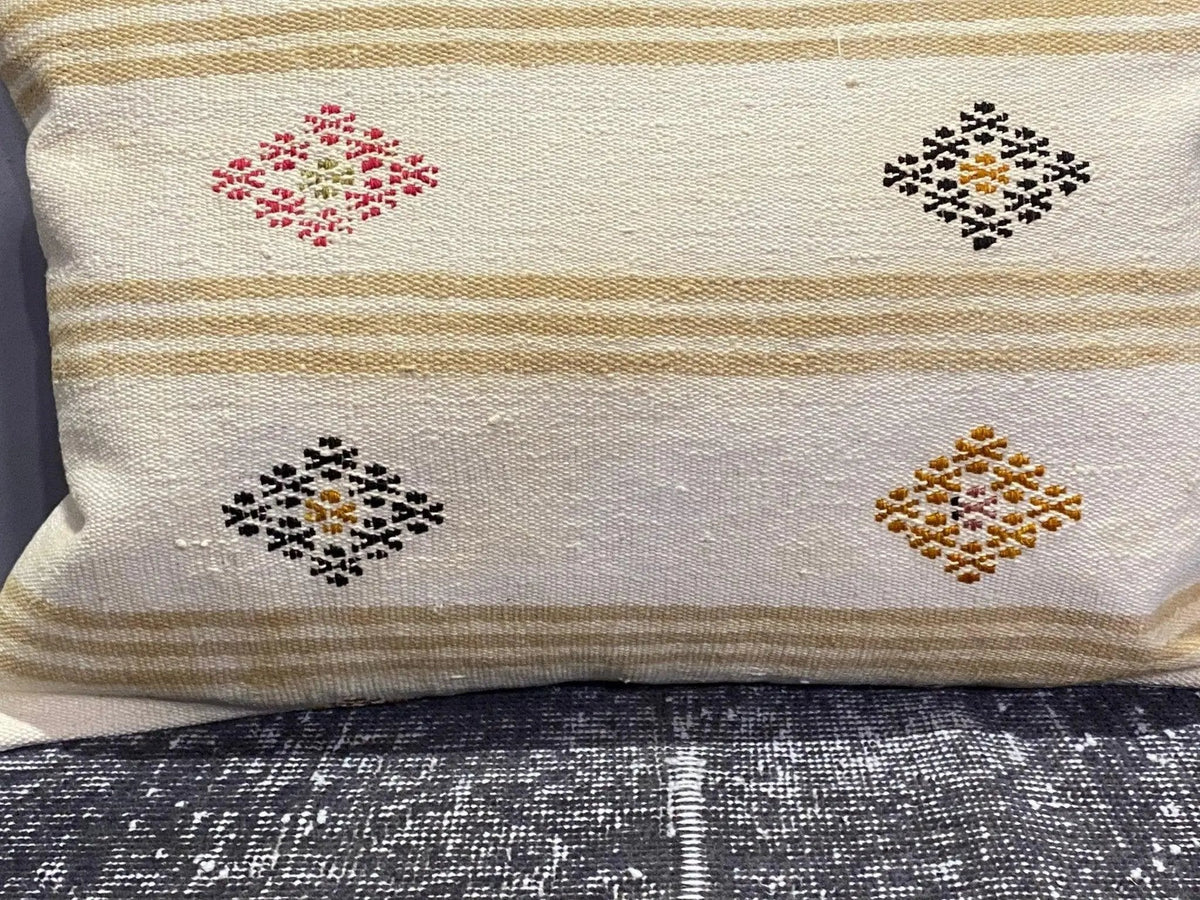 Close-up of the white Turkish throw pillow showing striped details, low pile.
