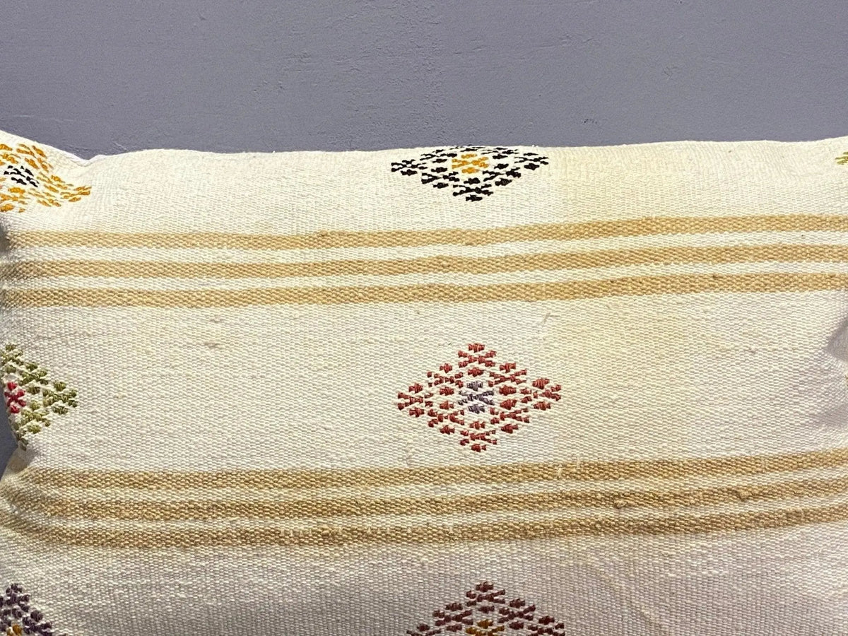Close-up of the white Turkish throw pillow showing striped details, low pile.