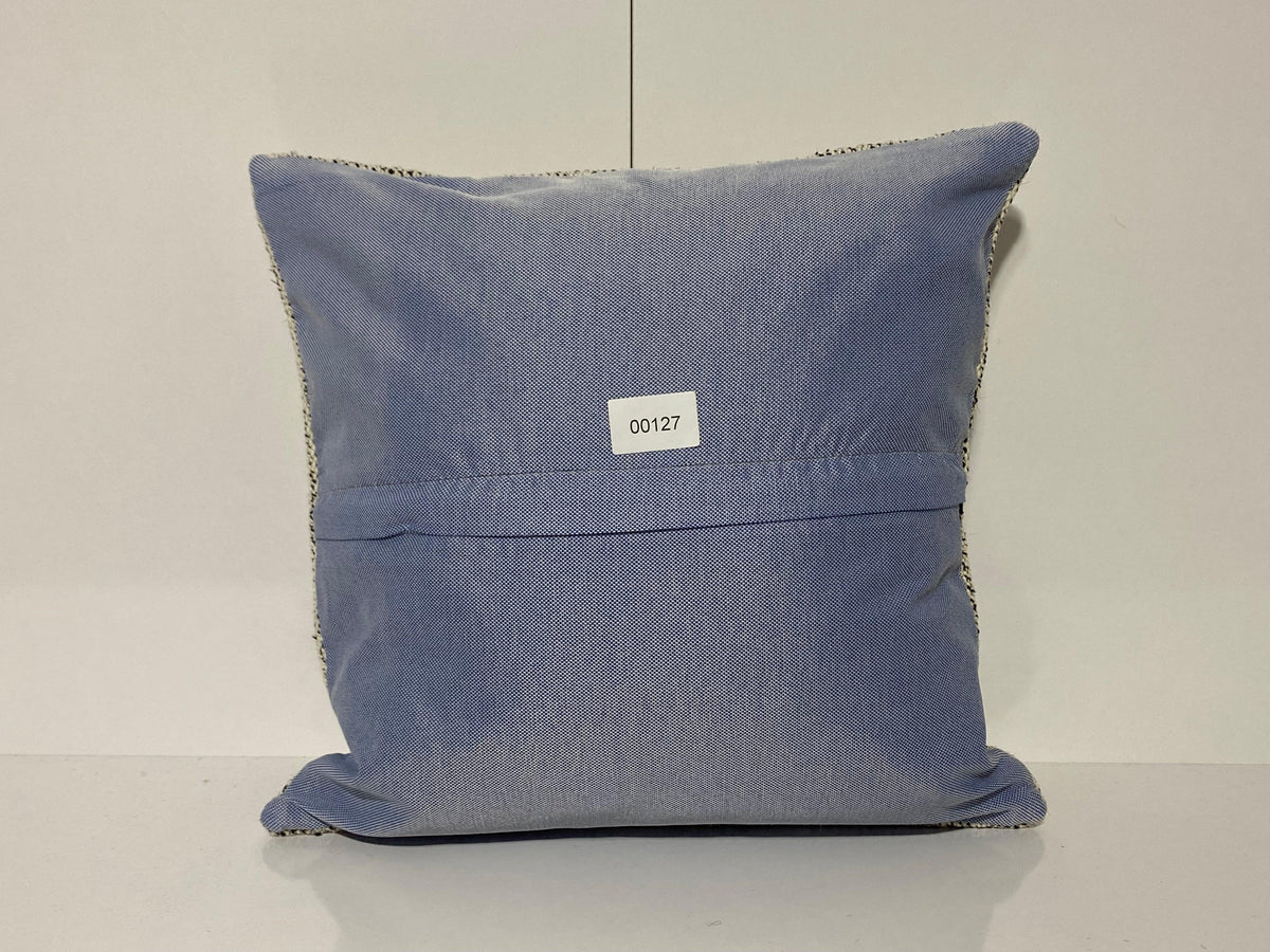 Close-up of the white Turkish throw pillow showing traditional details, low pile.