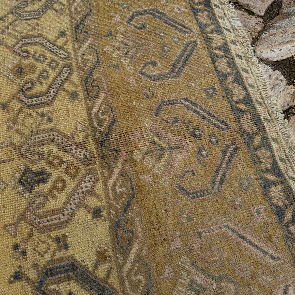 Close-up of the yellow Turkish traditional wool rug showing neutral details, hand-knotted weave, wool and cotton and low pile.