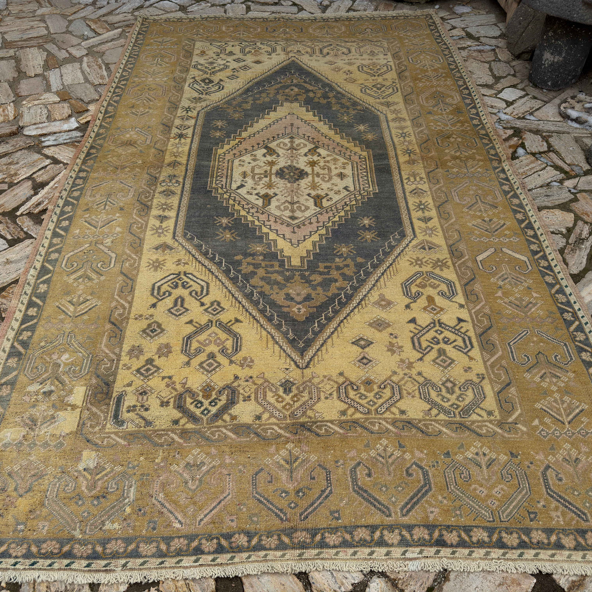 Yellow 7' x 11' Turkish traditional wool rug in wool and cotton, shown on the floor.