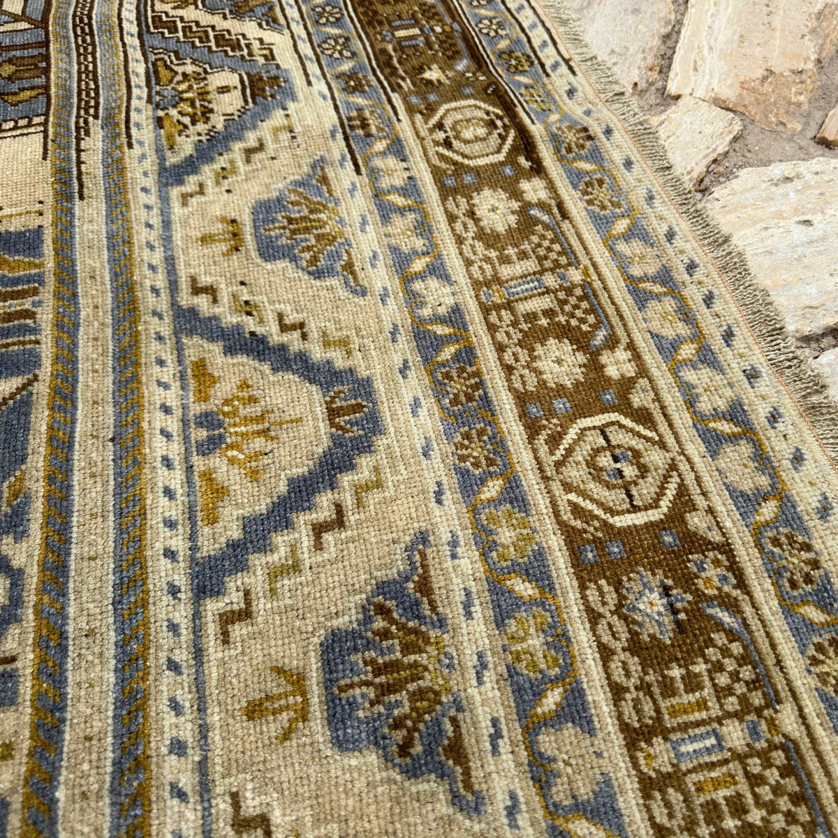 Close-up of the blue turkish area rug showing traditional details, hand-knotted weave, wool and cotton and low pile.