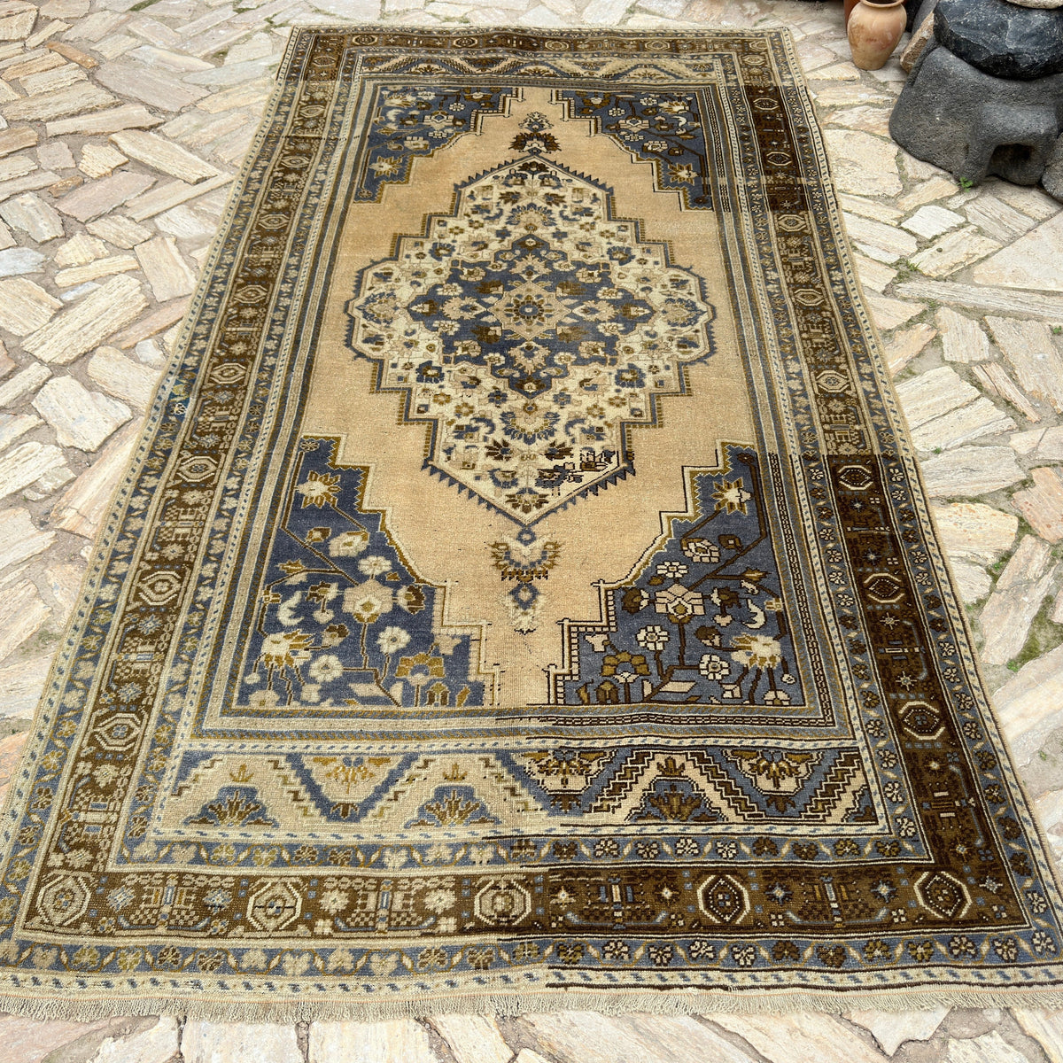 Blue 5' x 10' turkish area rug in wool and cotton, shown on the floor.