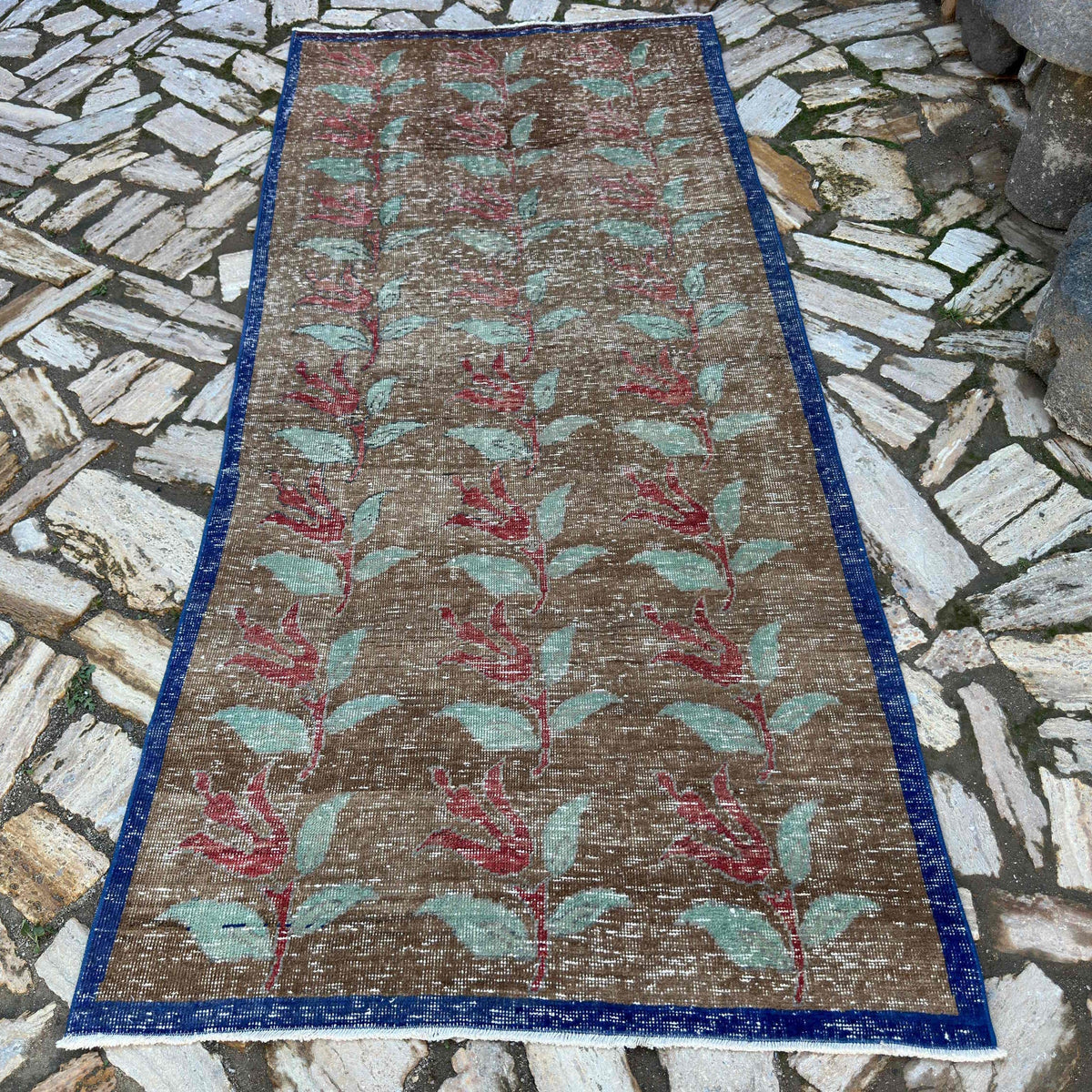 Pale Brown 4' x 9' turkish floral rug in wool and cotton, shown on the floor.
