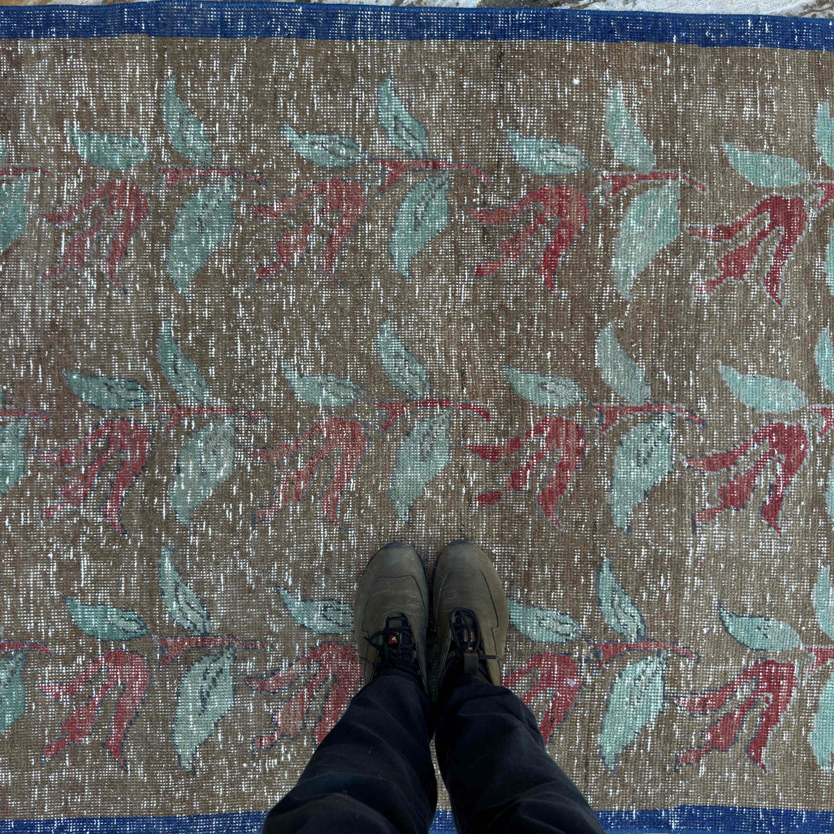 1970s pale brown turkish floral rug with floral design, hand-knotted weave and low pile.