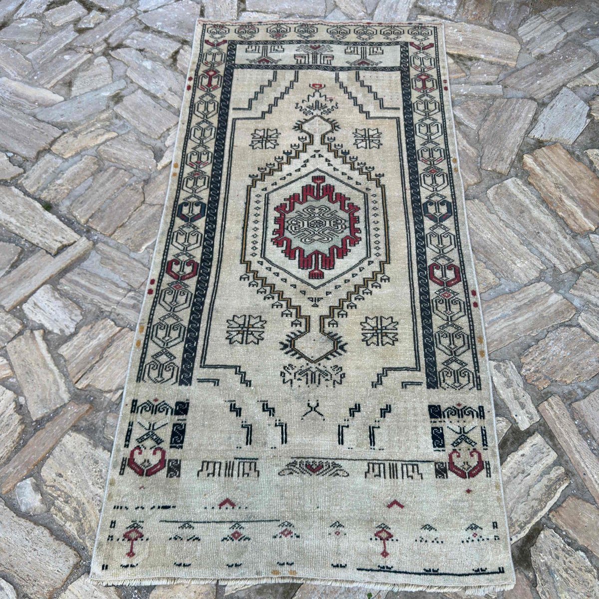 Red 3' x 6' turkish geometric rug in wool and cotton, shown on the floor.