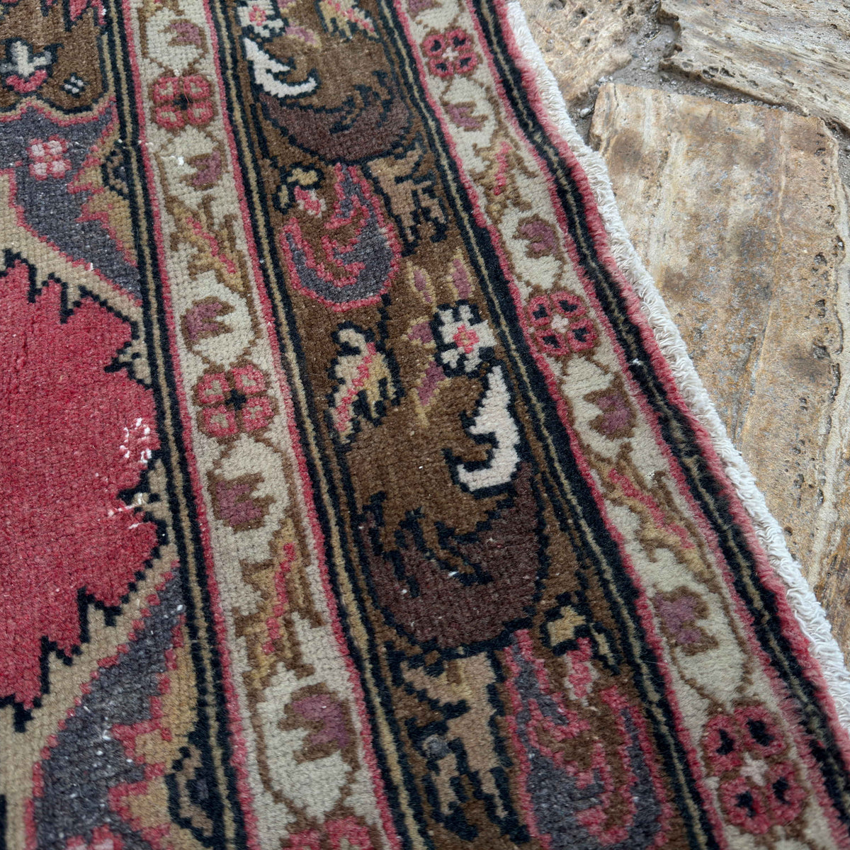 Close-up of the red turkish geometric runner rug showing traditional details, hand-knotted weave, wool and cotton and low pile.