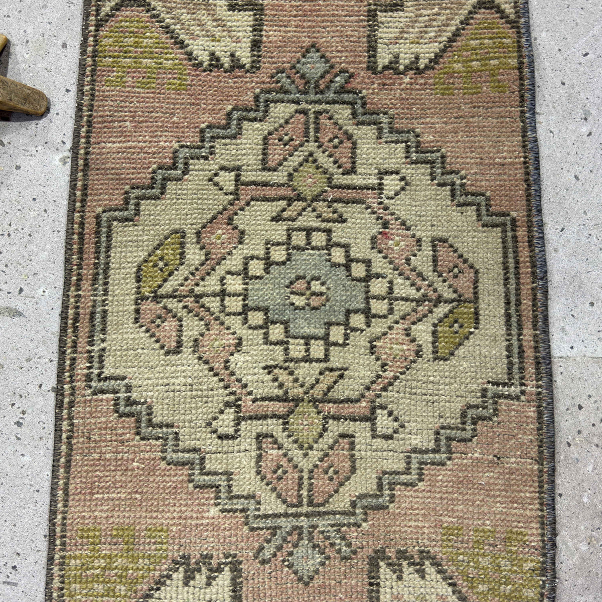 1970s pink turkish mini rug with traditional design, hand-knotted weave and low pile.