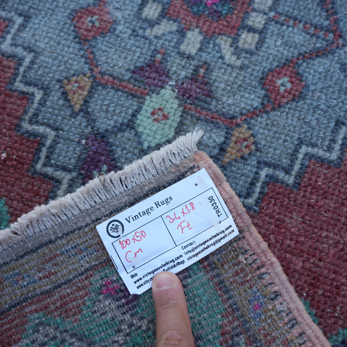 Red 2' x 3' turkish mini rug from the 1970s with traditional design.