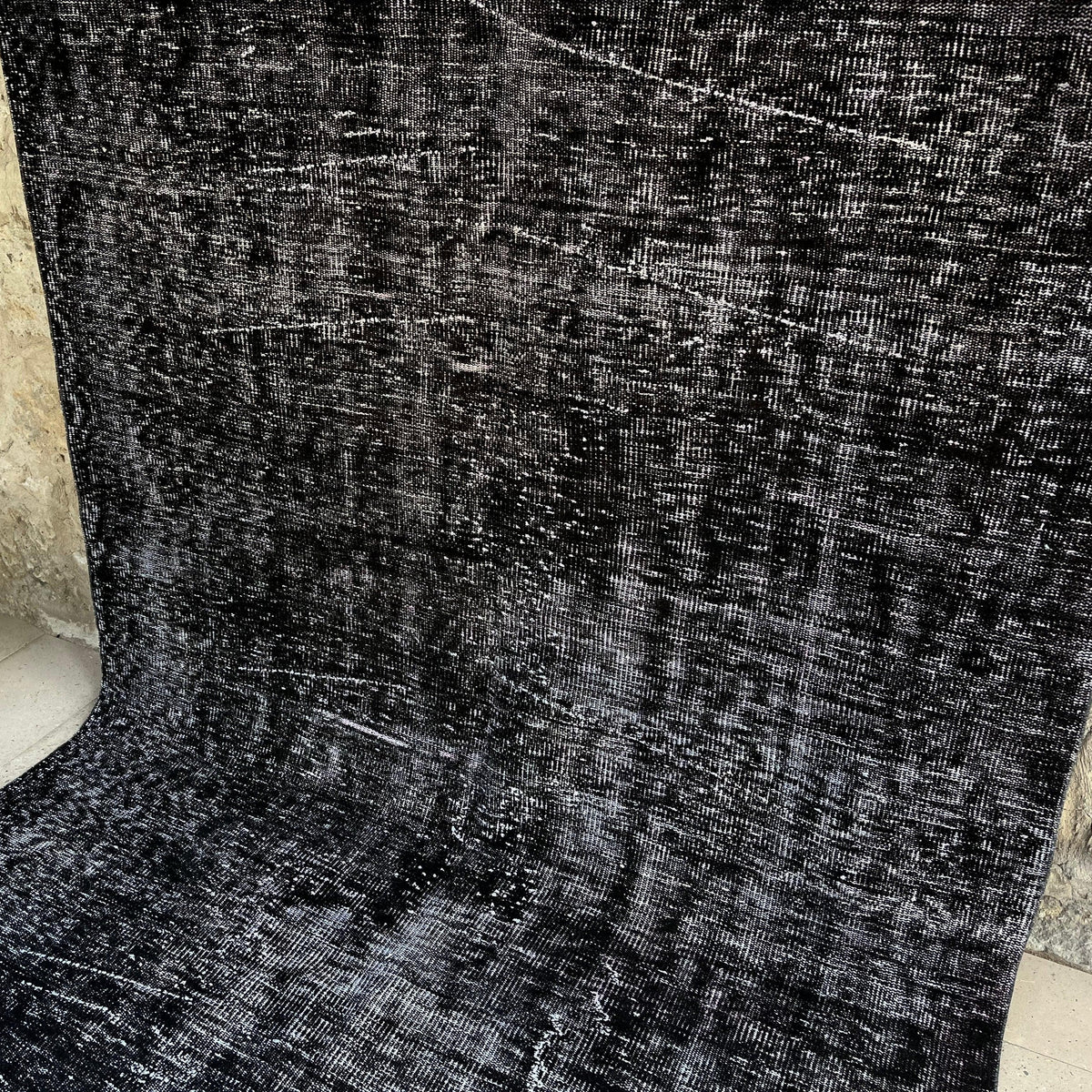 Gray 6' x 10' turkish overdyed rug in wool and cotton, shown on the floor.