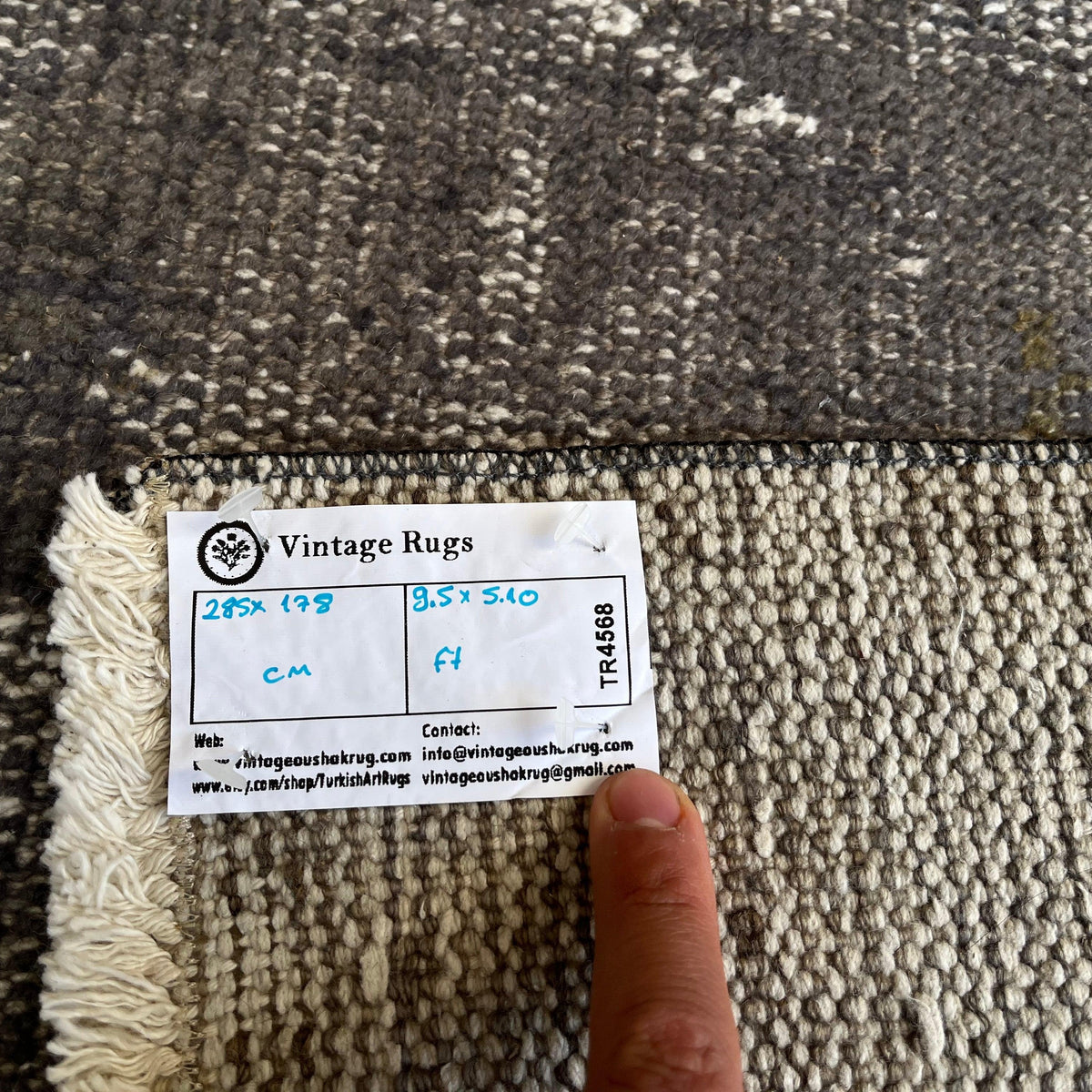 1970s black turkish overdyed rug with overdyed design, hand-knotted weave and low pile.
