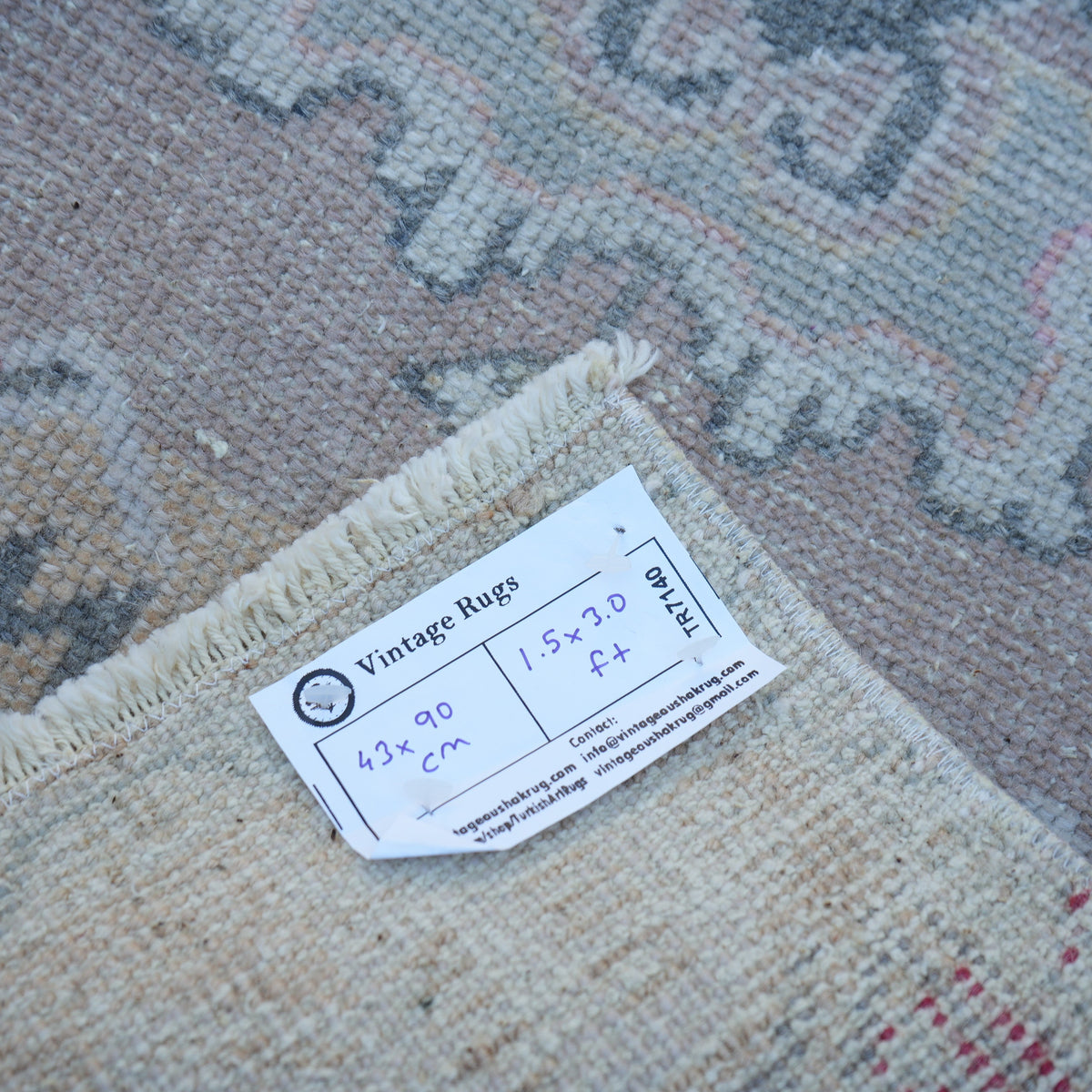 Pink 1' x 3' turkish rug from the 1970s with neutral design.