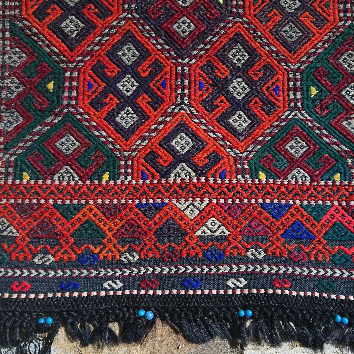 Orange 2' x 4' turkish rug in wool and cotton, shown on the floor.