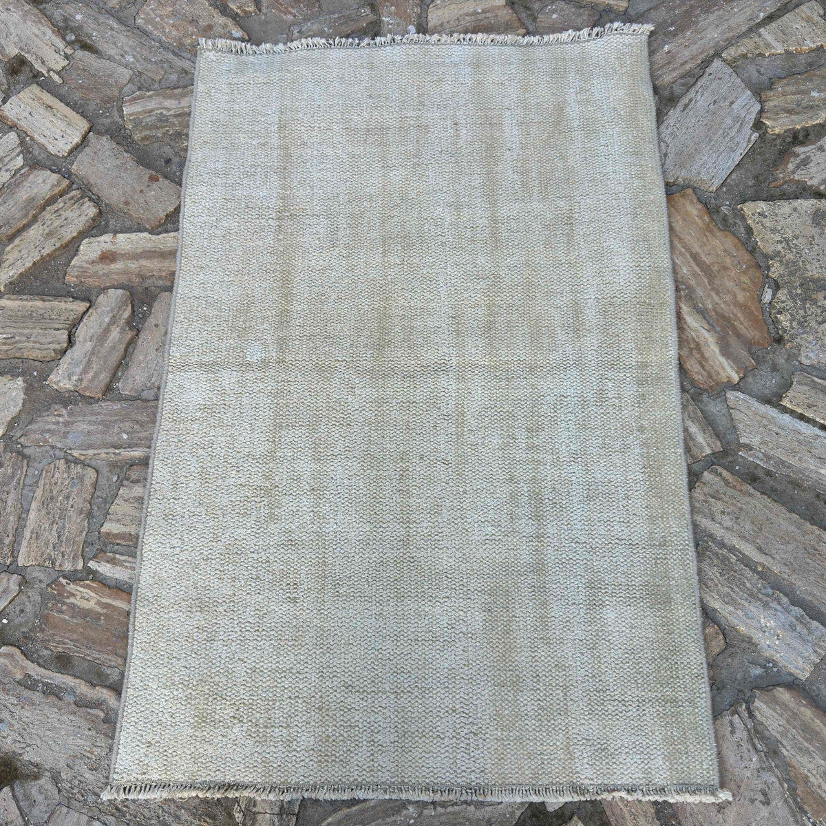 Beige 3' x 4' turkish rug in wool and cotton, shown on the floor.
