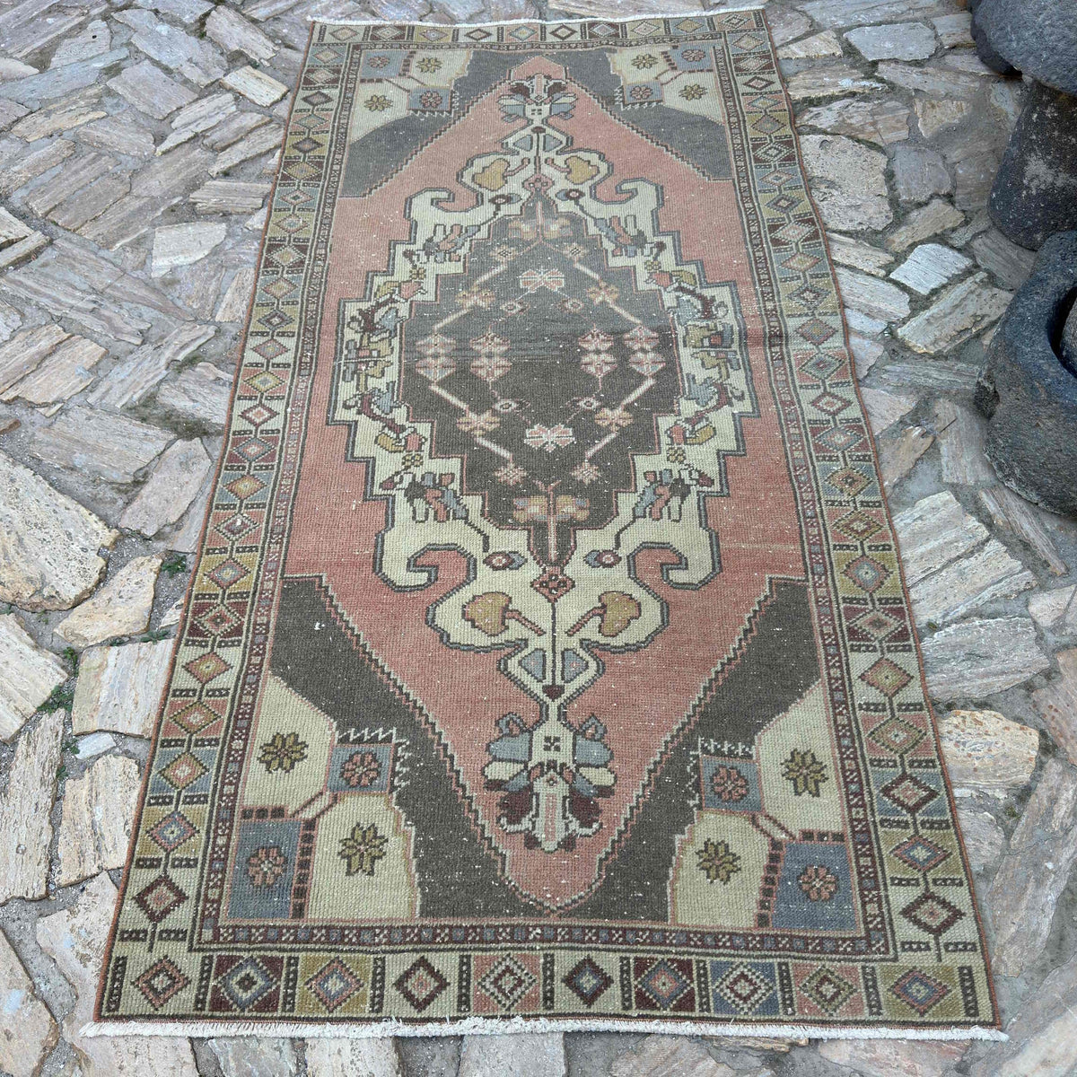 Pale Red 4' x 8' turkish rug in wool and cotton, shown on the floor.