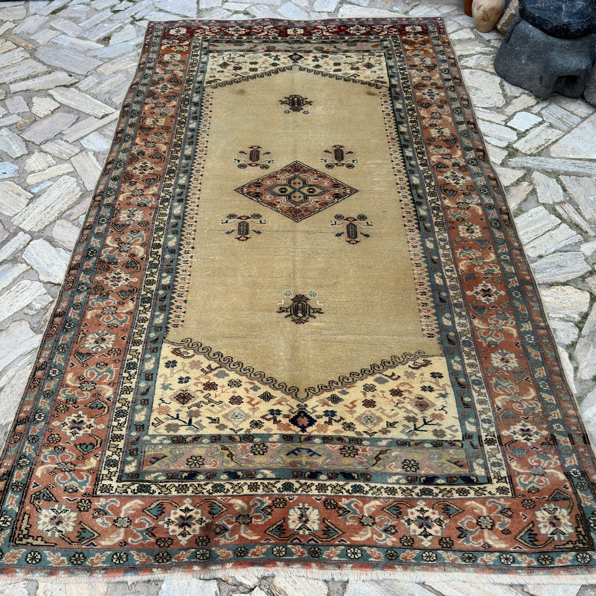 Beige 6' x 10' turkish rug in wool and cotton, shown on the floor.