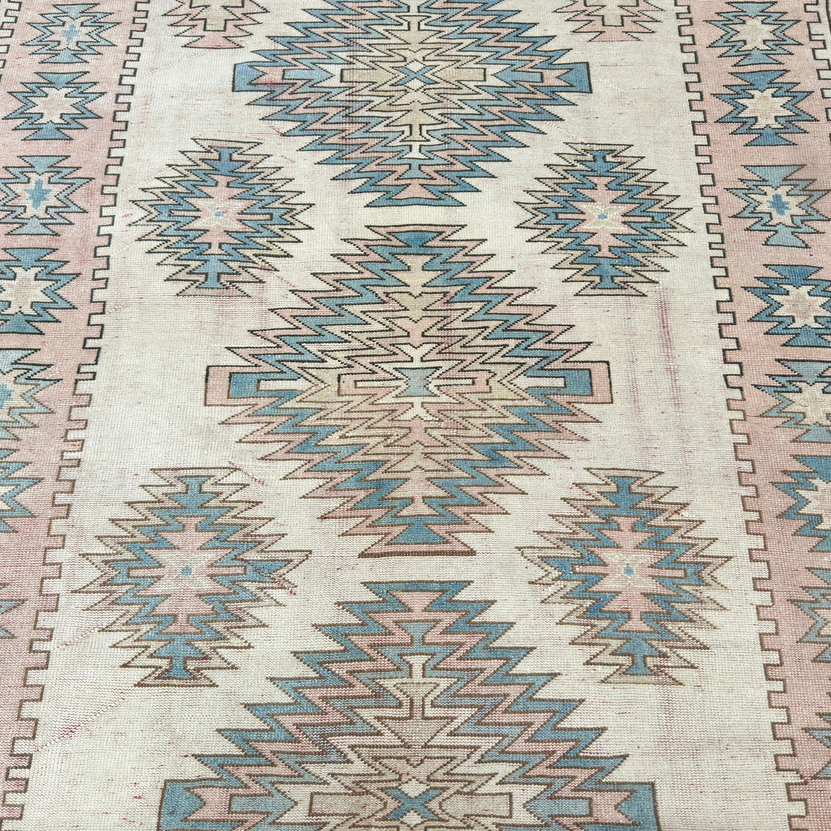 1970s pink turkish rug with traditional design, hand-knotted weave and low pile.