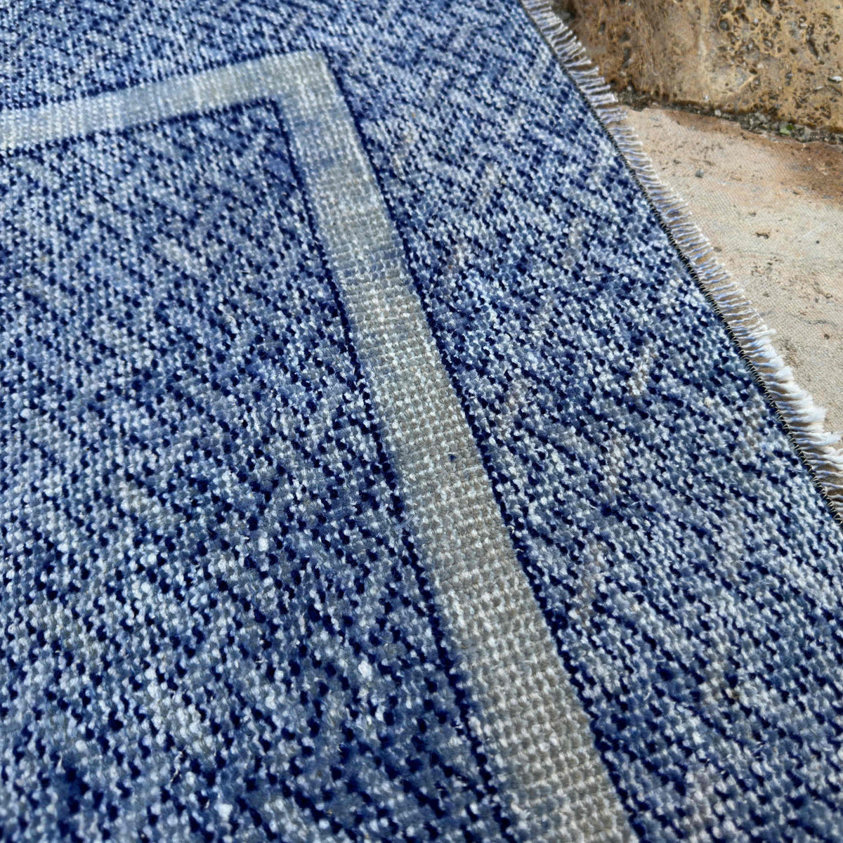 Close-up of the blue turkish runner rug showing traditional details, hand-knotted weave, wool and cotton and low pile.