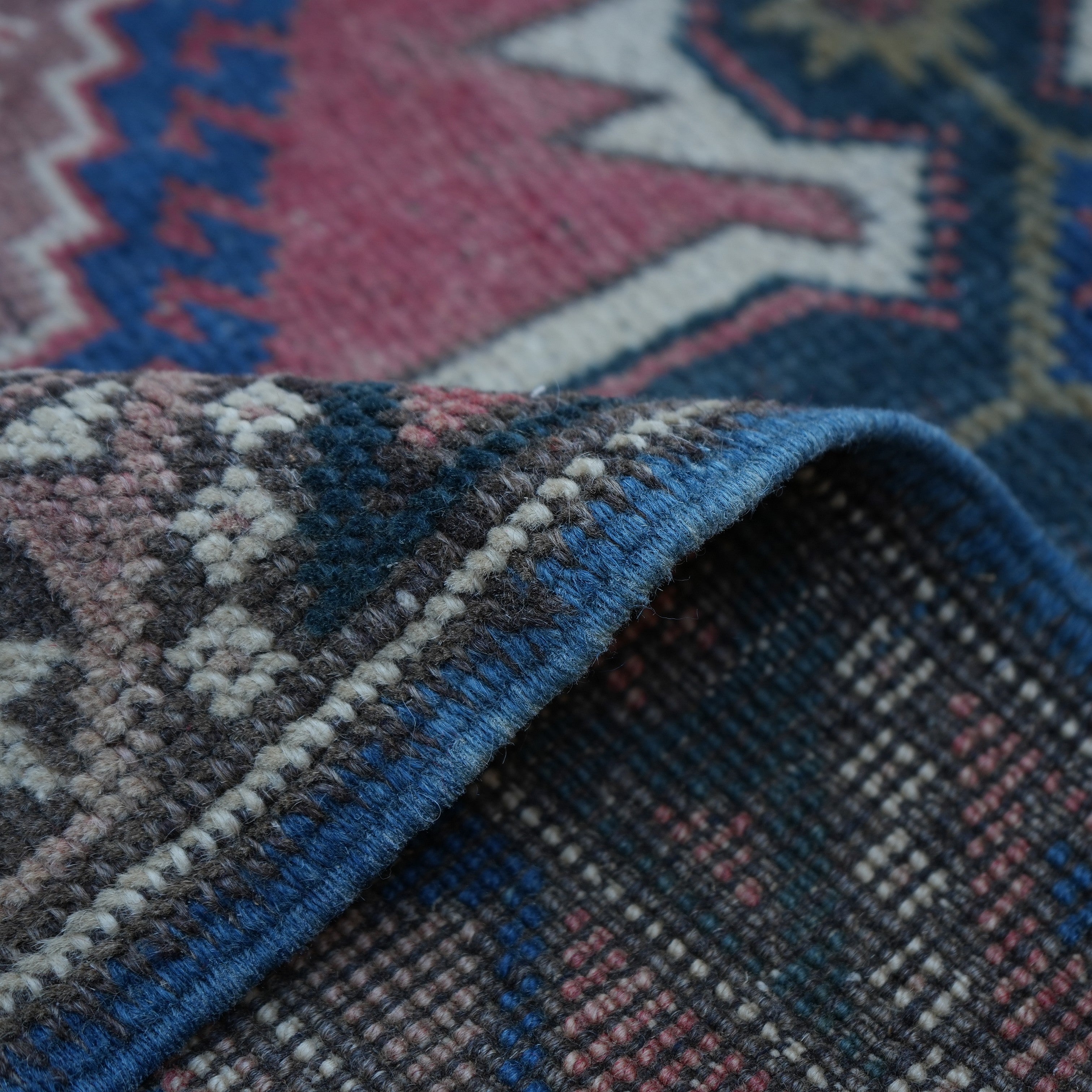 1970s red turkish runner rug with traditional design, hand-knotted weave and low pile.