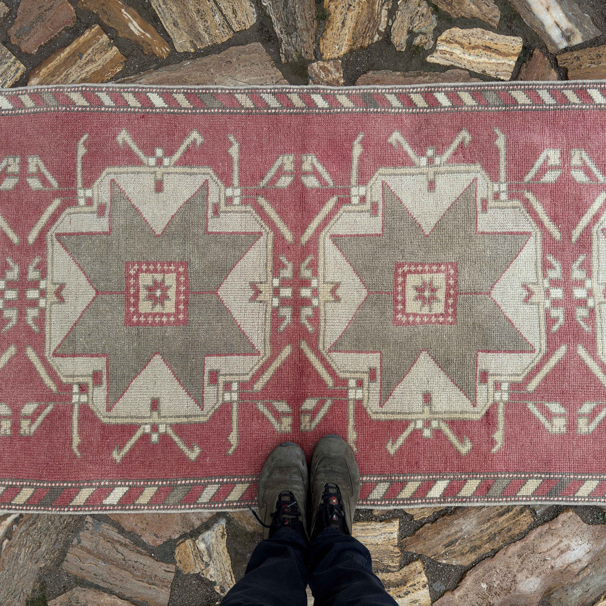 1970s pale red turkish runner rug with medallion design, hand-knotted weave and low pile.