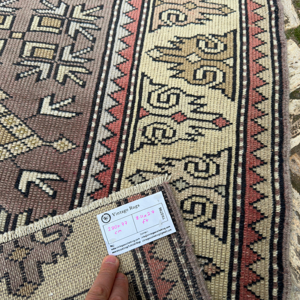 Close-up of the beige turkish runner rug showing geometric details, hand-knotted weave, wool and cotton and low pile.