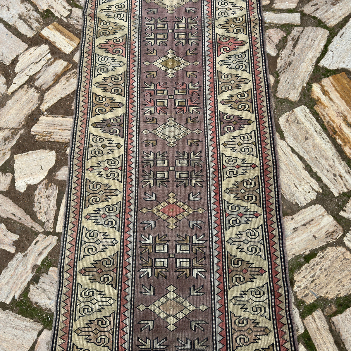 1970s beige turkish runner rug with geometric design, hand-knotted weave and low pile.
