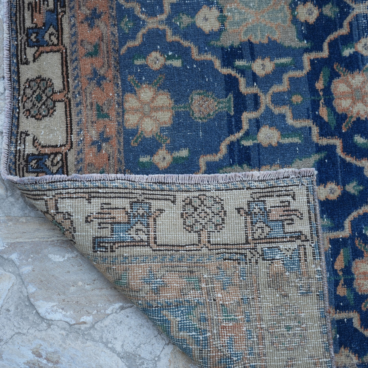1970s blue Turkish unique vintage rug with geometric design, hand-knotted weave and low pile.