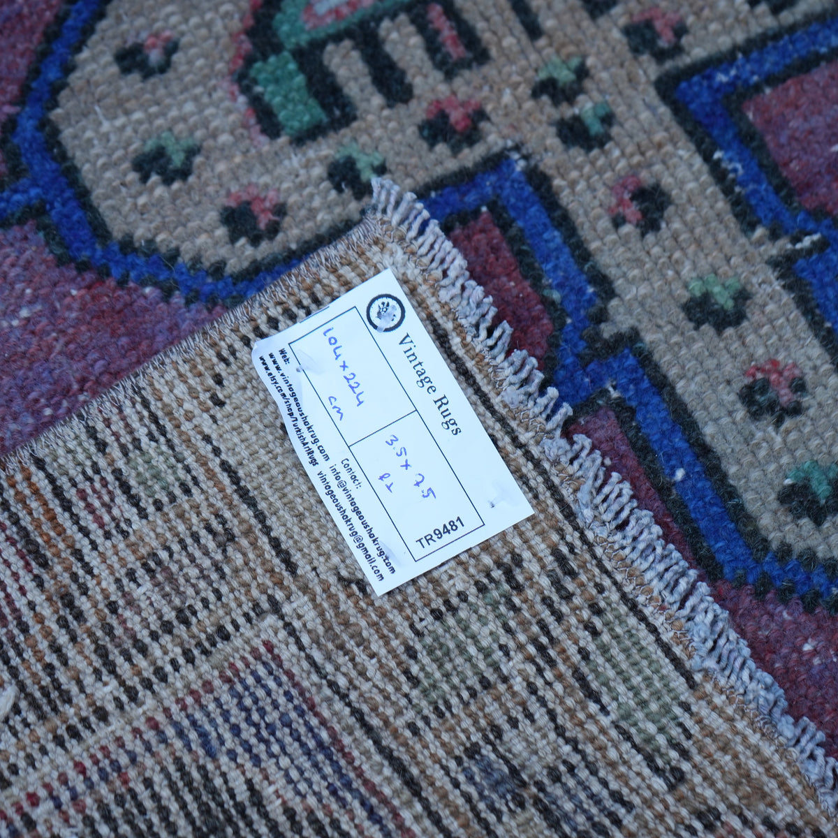 Red 3' x 7' vintage Turkish anatolian rug from the 1970s with traditional design.
