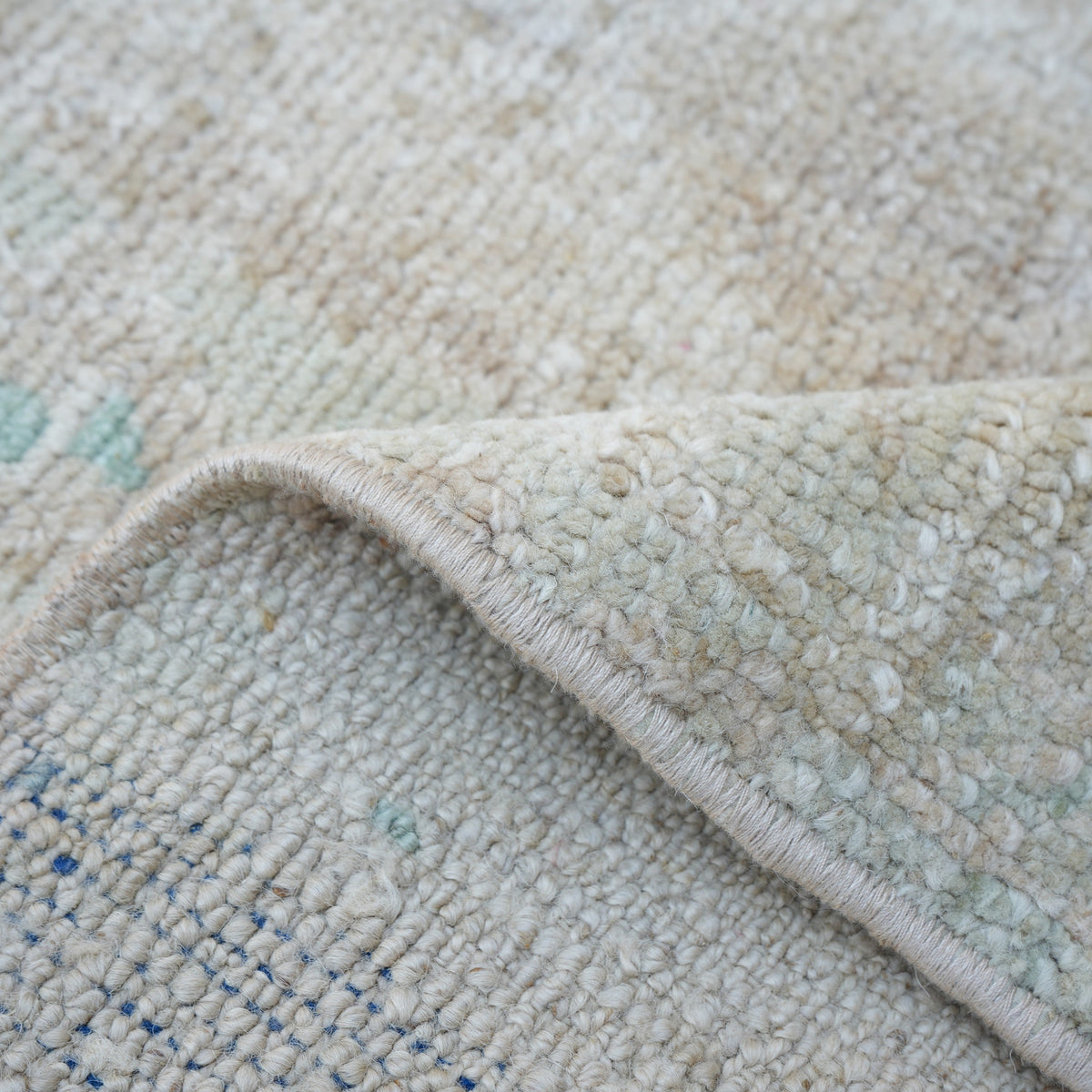 1970s beige vintage Turkish area rug with neutral design, hand-knotted weave and low pile.
