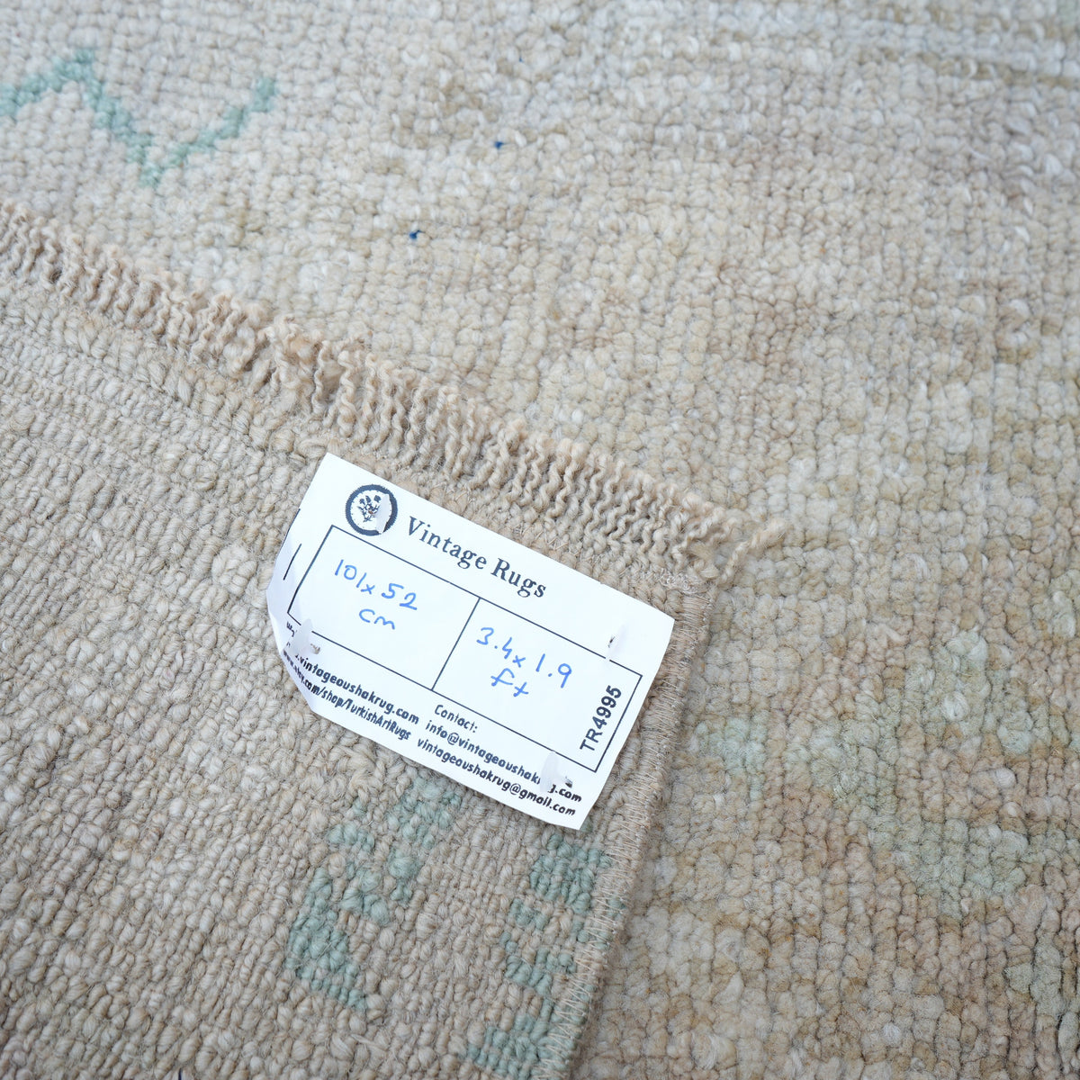 Beige 2' x 3' vintage Turkish area rug from the 1970s with neutral design.