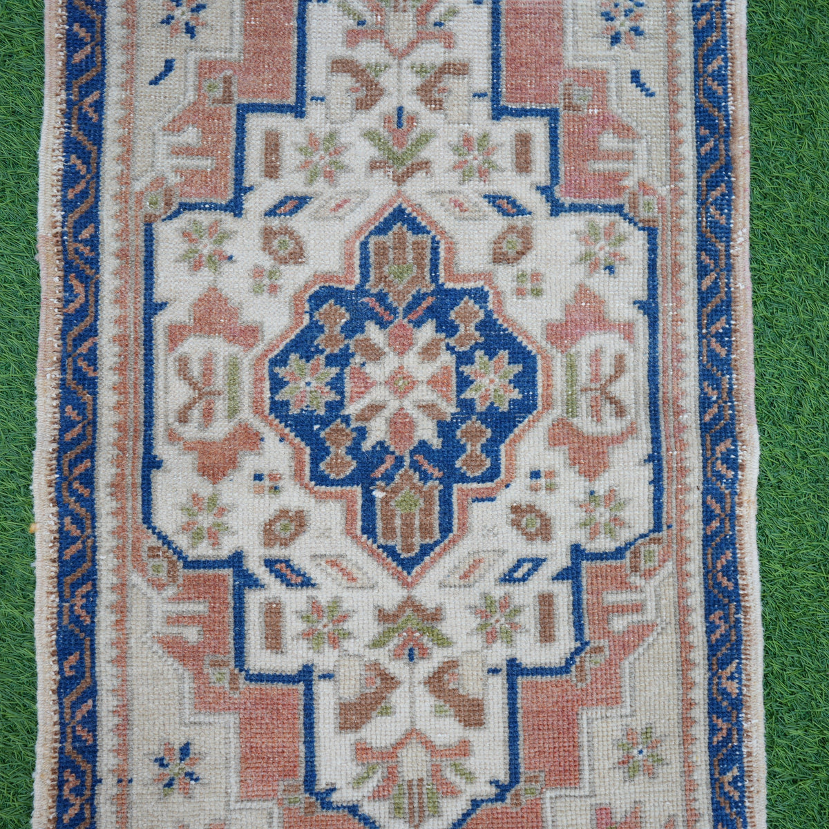 Close-up of the blue vintage Turkish area rug showing traditional details, hand-knotted weave, wool and cotton and low pile.