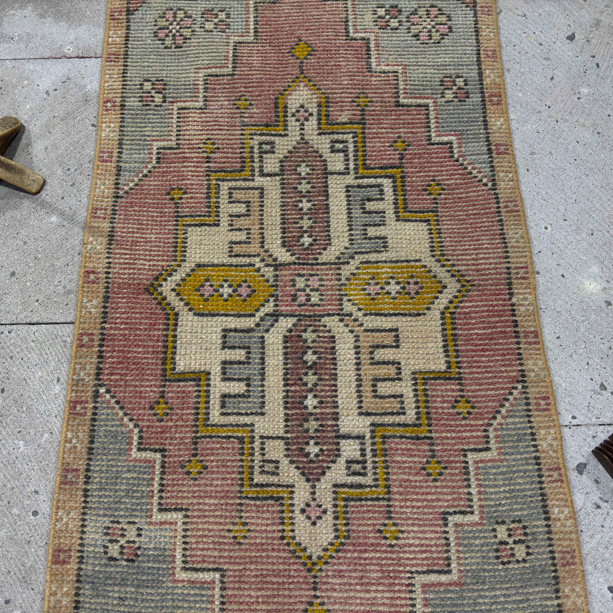 1970s red vintage Turkish area rug with medallion design, hand-knotted weave and low pile.