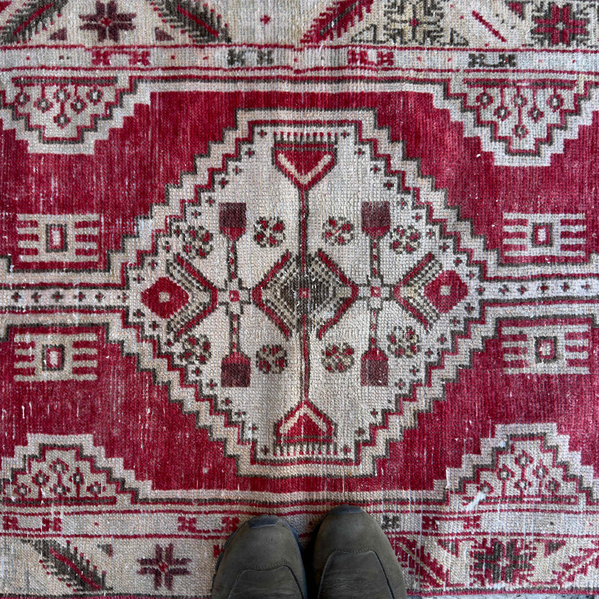 1970s red vintage Turkish area rug with geometric design, hand-knotted weave and low pile.