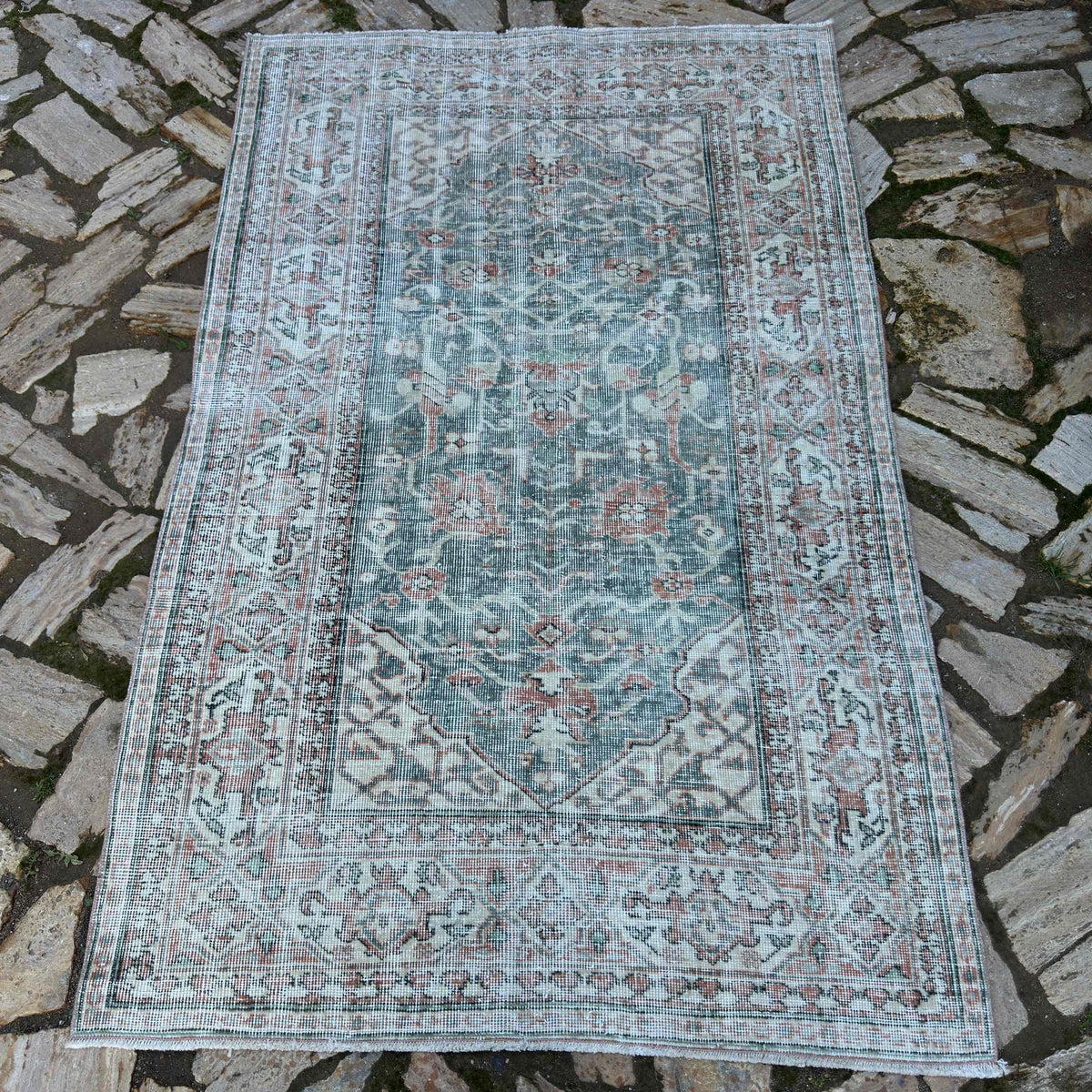 Green 4' x 6' vintage Turkish area rug in wool and cotton, shown on the floor.