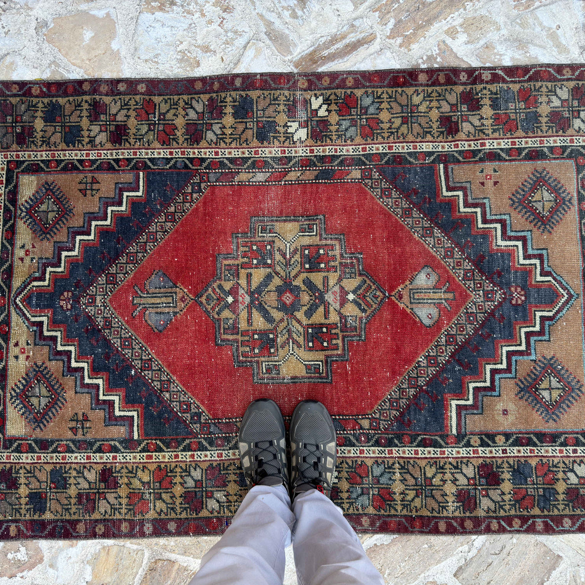 1970s red vintage Turkish area rug with traditional design, hand-knotted weave and low pile.