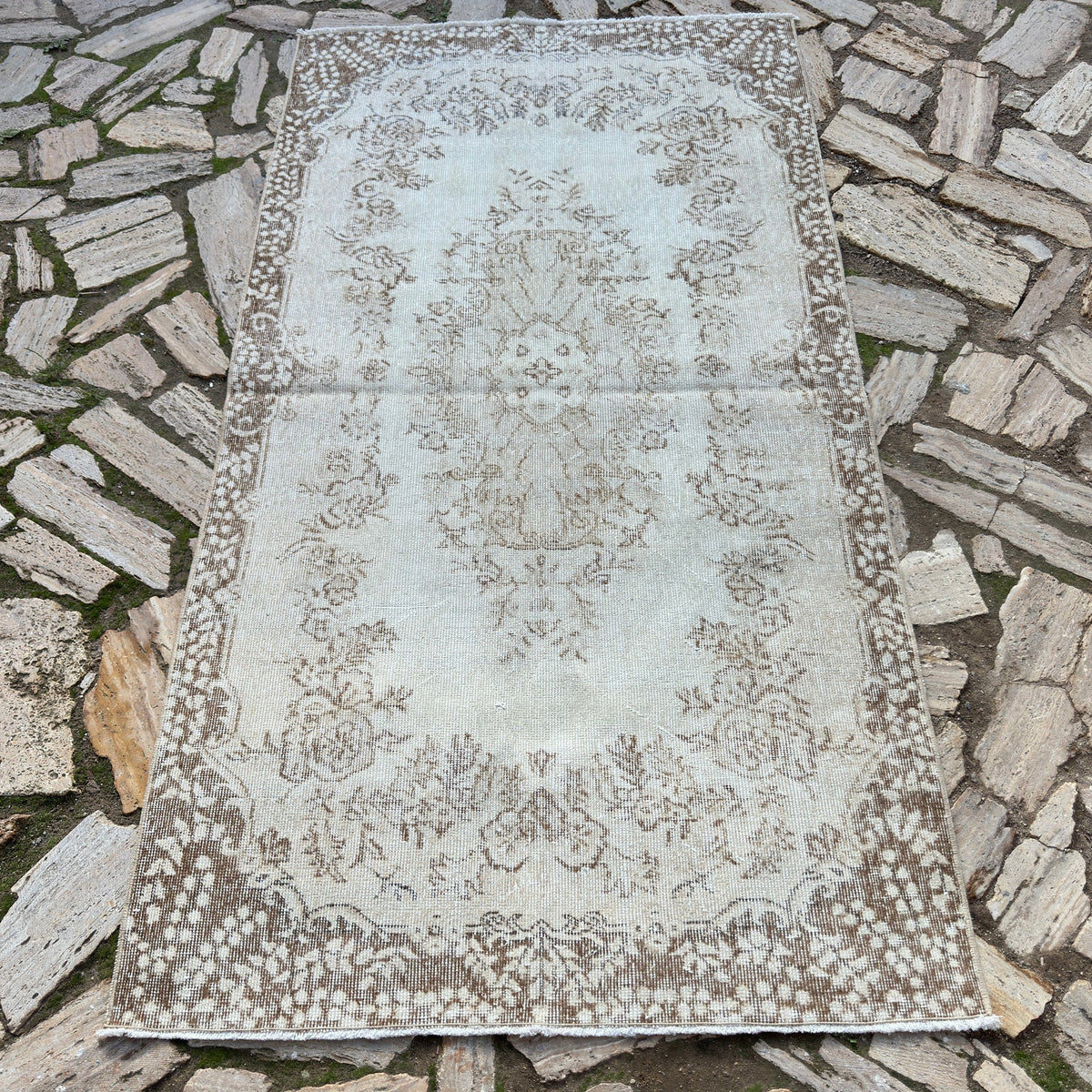 Beige 4' x 7' vintage Turkish area rug in wool and cotton, shown on the floor.
