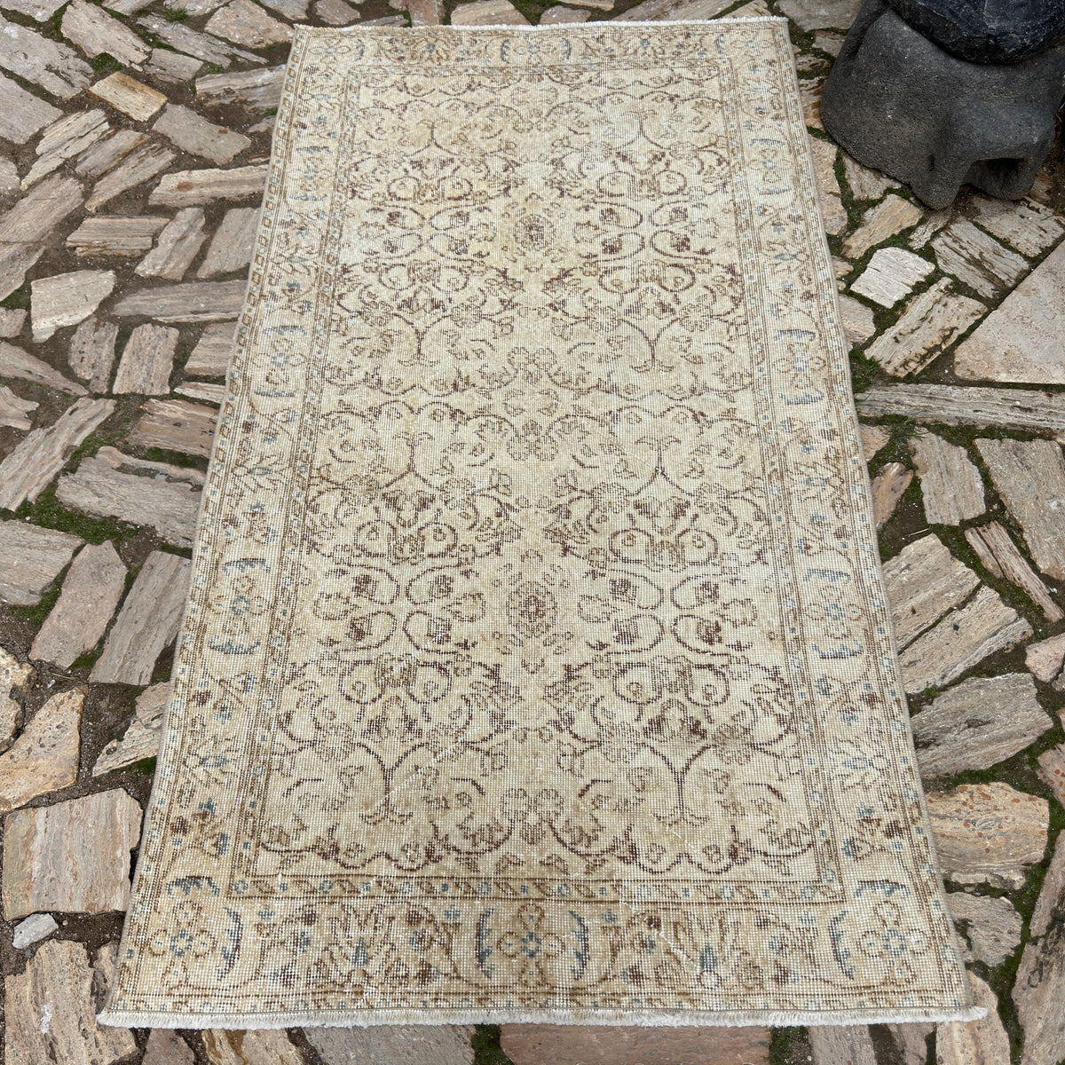 Beige 4' x 7' vintage Turkish area rug in wool and cotton, shown on the floor.