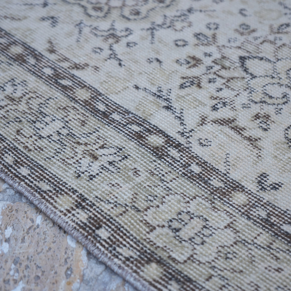 Beige 4' x 7' vintage Turkish area rug in wool and cotton, shown on the floor.