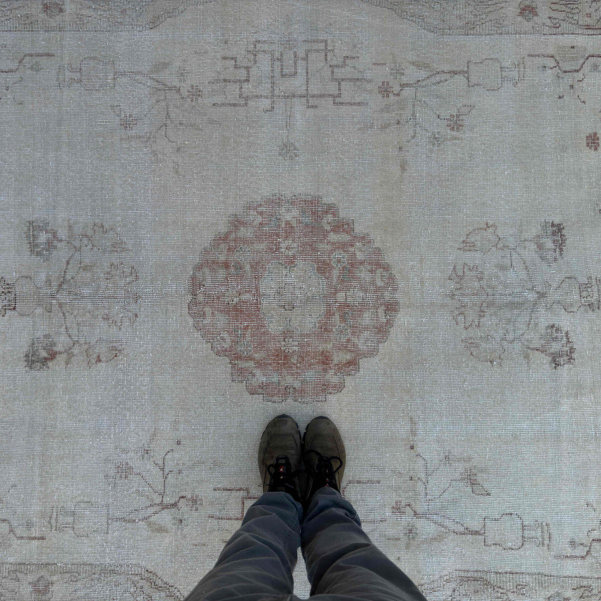 1970s pale red vintage Turkish area rug with medallion design, hand-knotted weave and low pile.