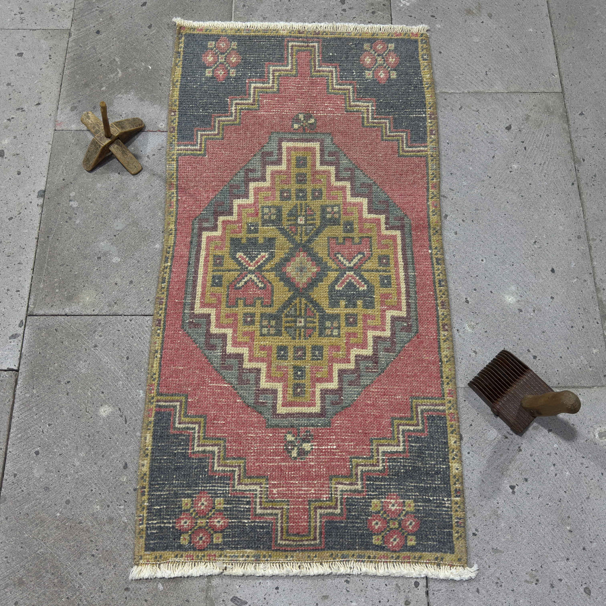 Red 1' x 3' vintage Turkish distressed rug in wool and cotton, shown on the floor.