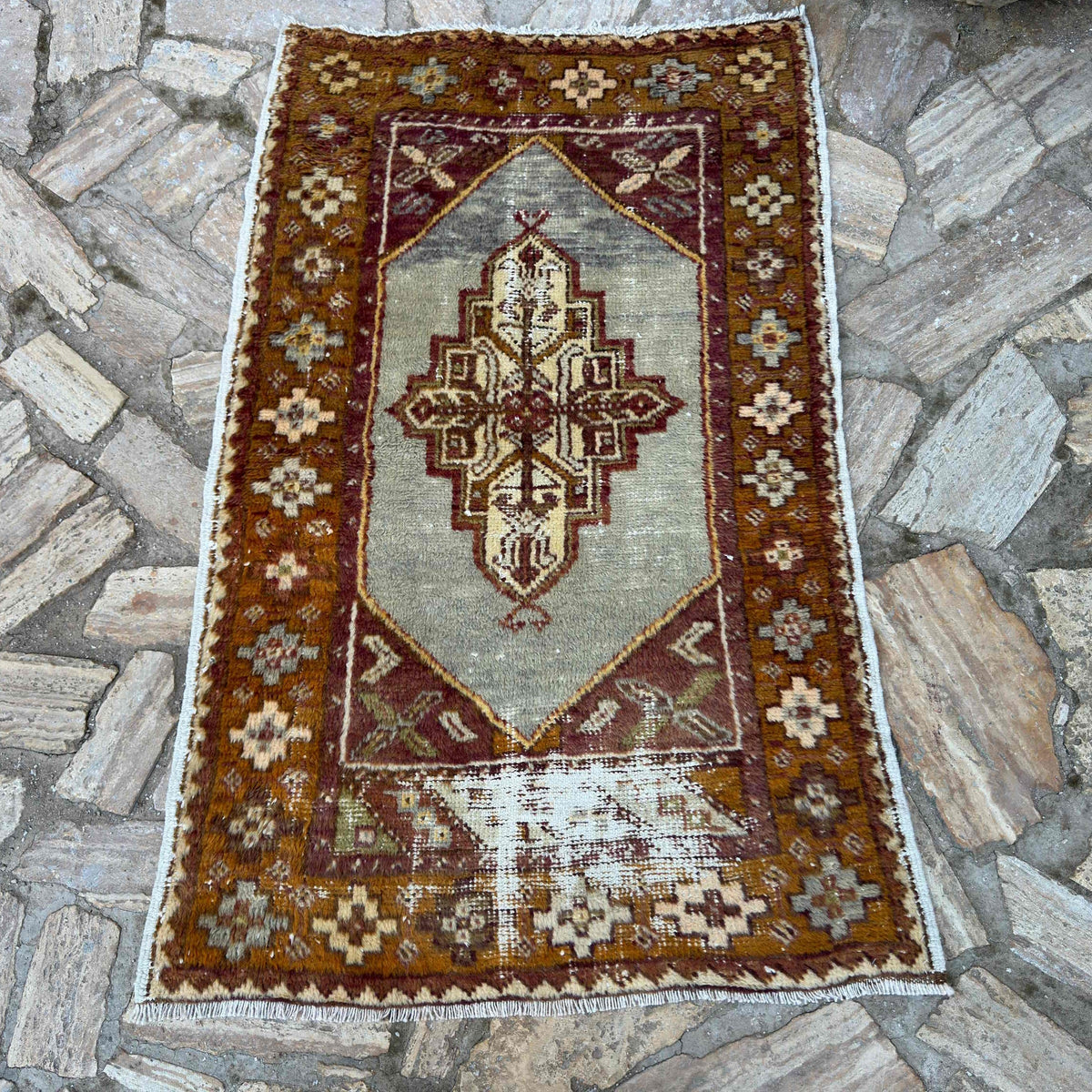 Orange 3' x 4' vintage Turkish distressed rug in wool and cotton, shown on the floor.