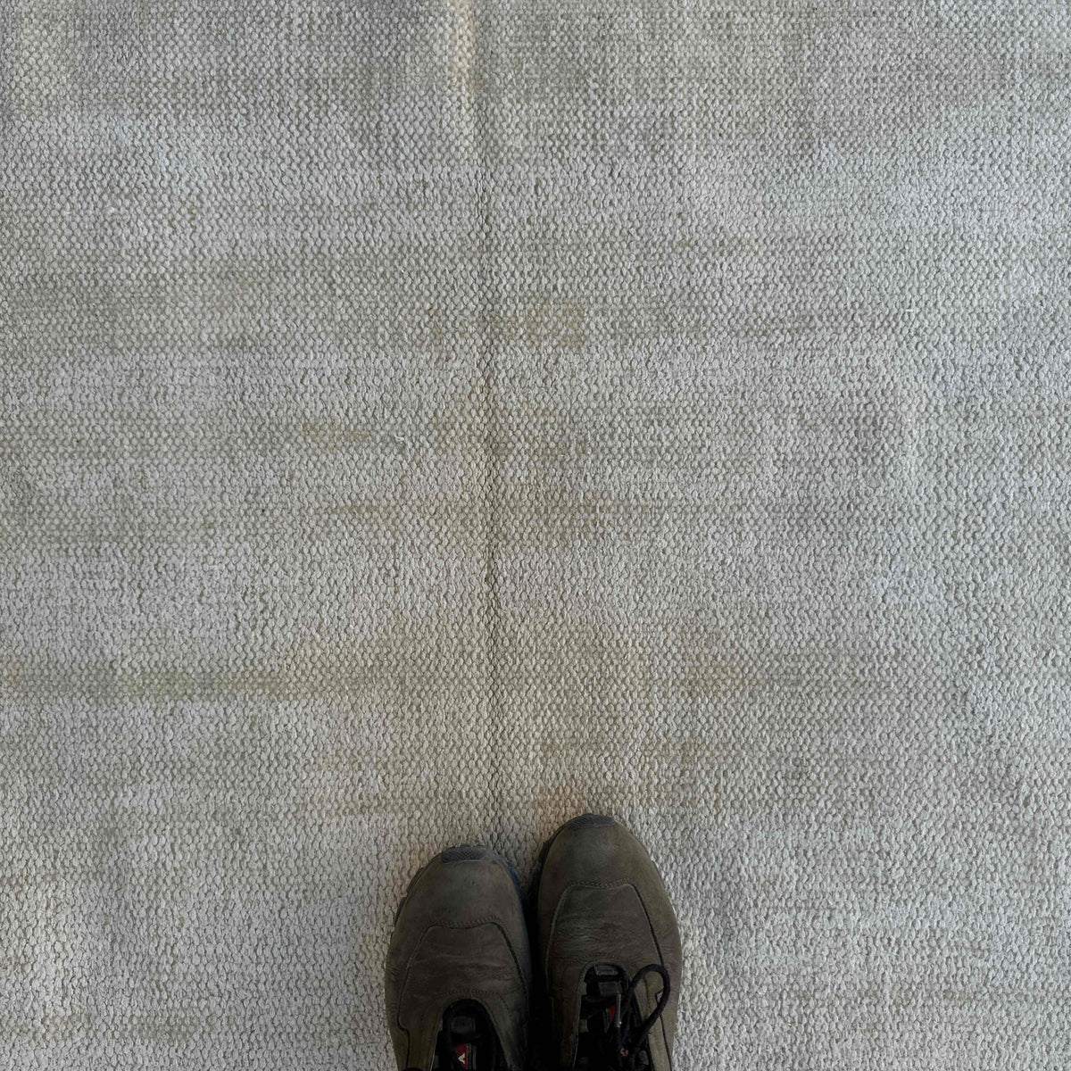 1970s beige vintage Turkish distressed rug with neutral design, hand-knotted weave and low pile.