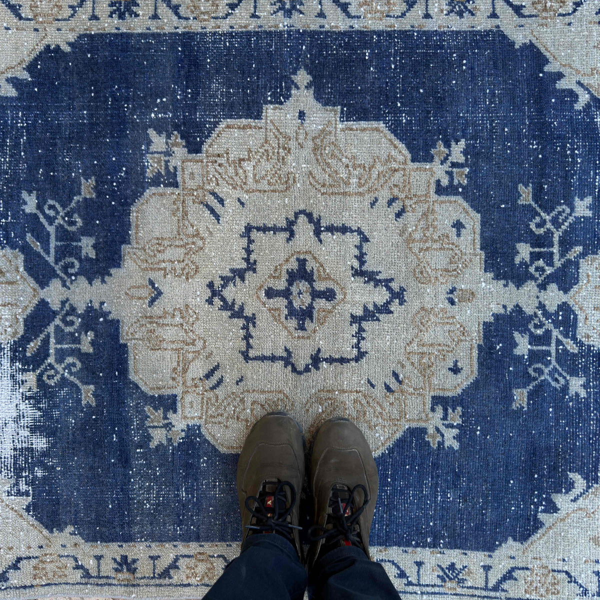 1970s blue vintage Turkish distressed rug with traditional design, hand-knotted weave and low pile.