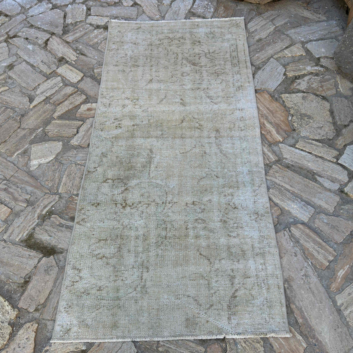 Beige 3' x 6' vintage Turkish distressed rug in wool and cotton, shown on the floor.