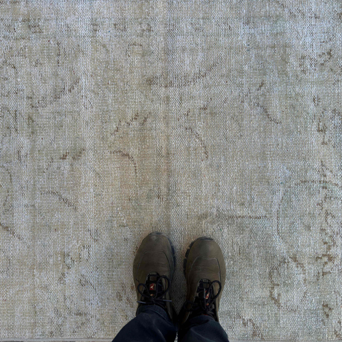 1970s beige vintage Turkish distressed rug with neutral design, hand-knotted weave and low pile.