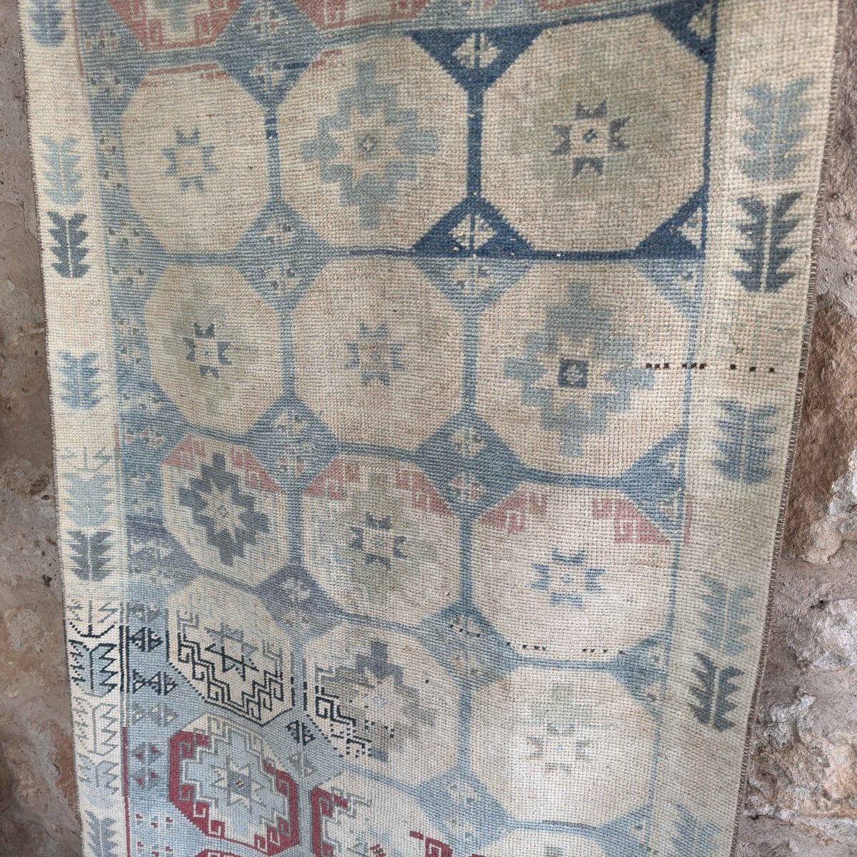 Blue 3' x 7' vintage Turkish distressed rug in wool and cotton, shown on the floor.