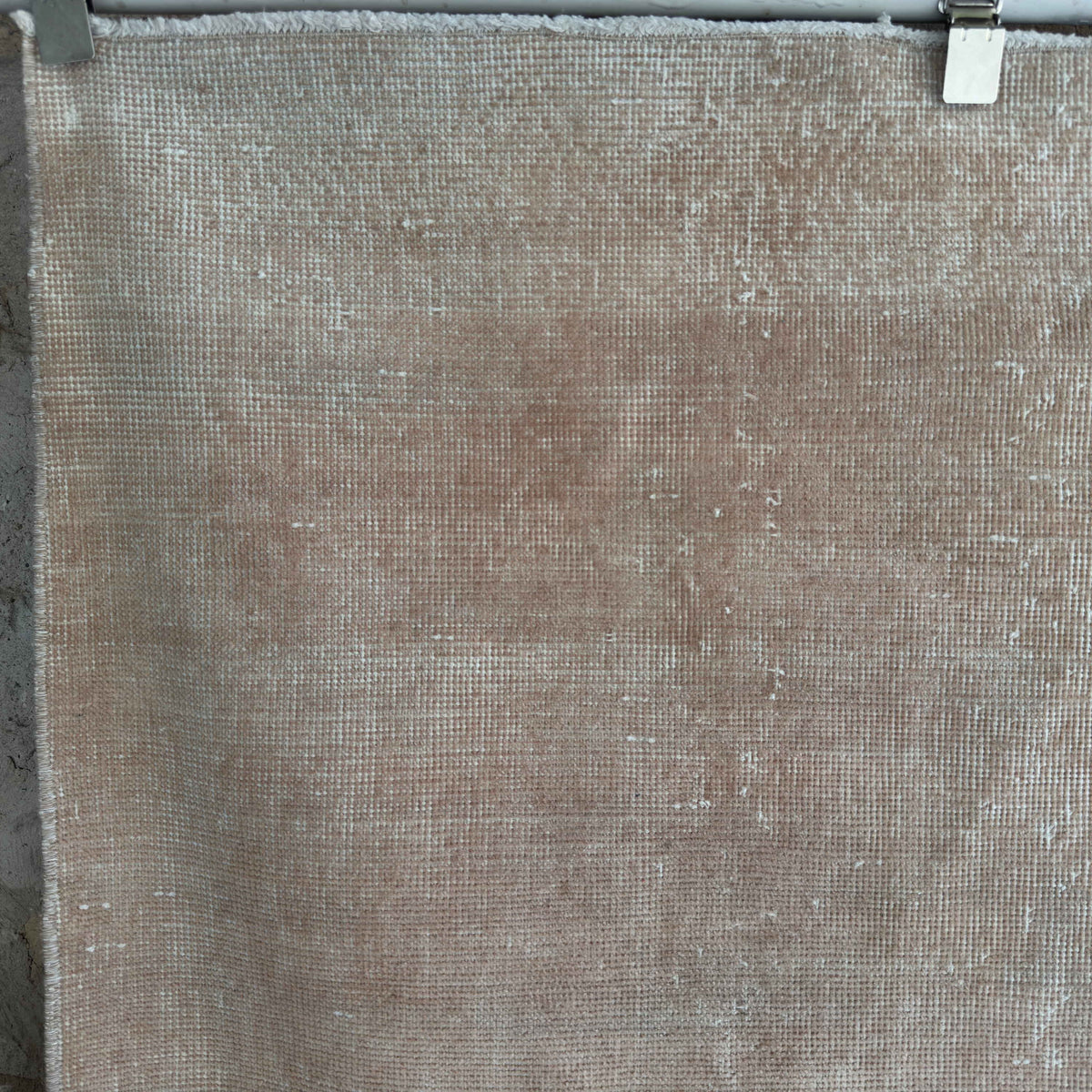 1970s beige vintage Turkish distressed rug with neutral design, hand-knotted weave and low pile.