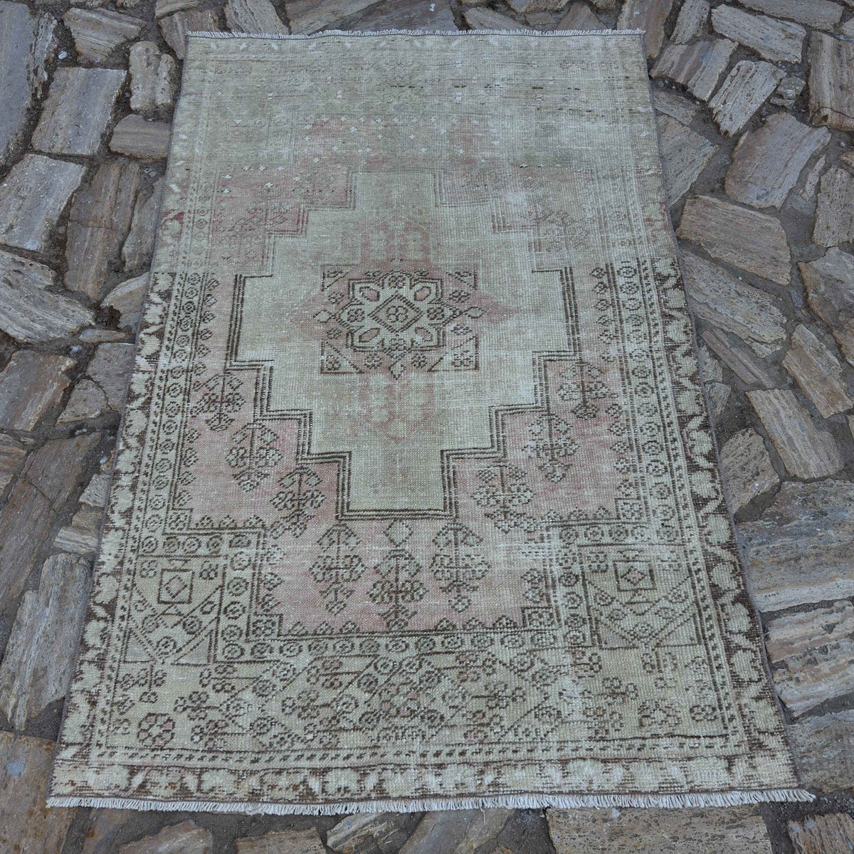 Pale Pink 4' x 6' vintage Turkish distressed rug in wool and cotton, shown on the floor.