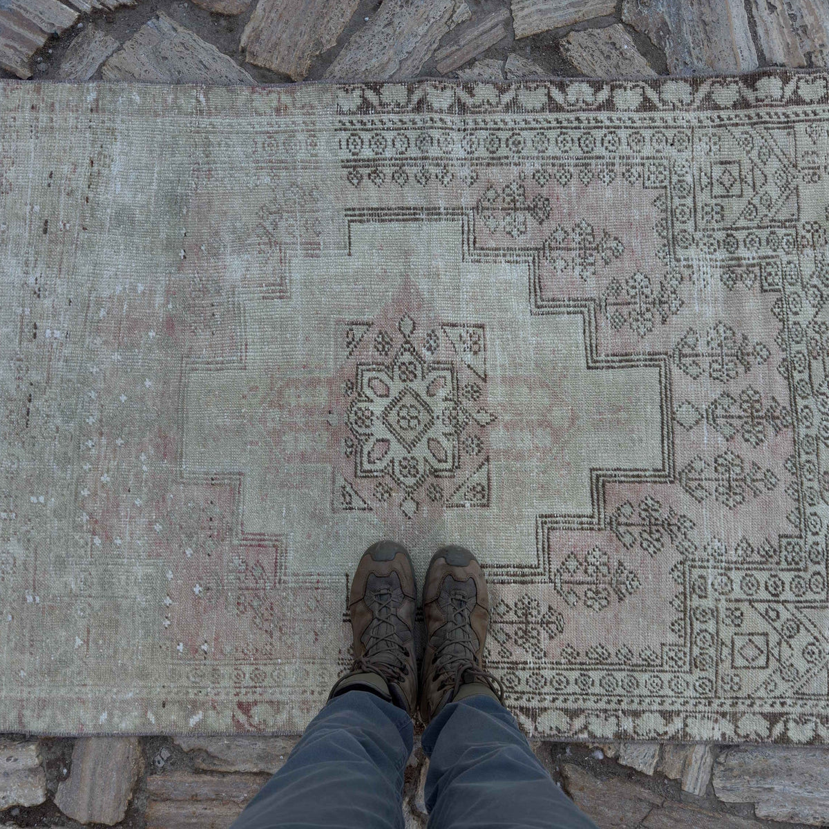 1970s pale pink vintage Turkish distressed rug with neutral design, hand-knotted weave and low pile.